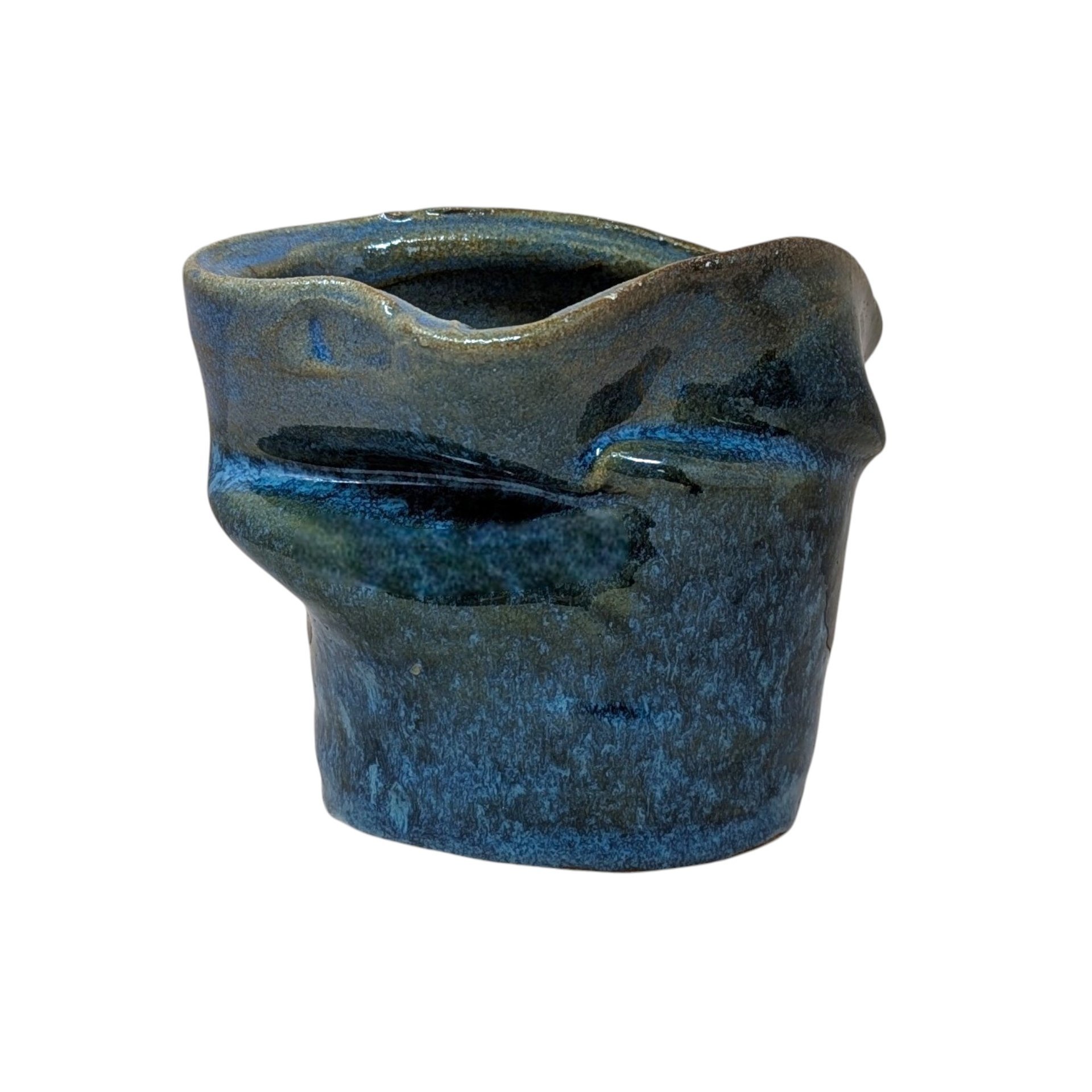 Vintage handmade studio pottery vase with an asymmetrical, pinched silhouette. Features a mottled deep blue and earth-toned glaze with a high-gloss finish. Signed on the base. 5 inches tall.