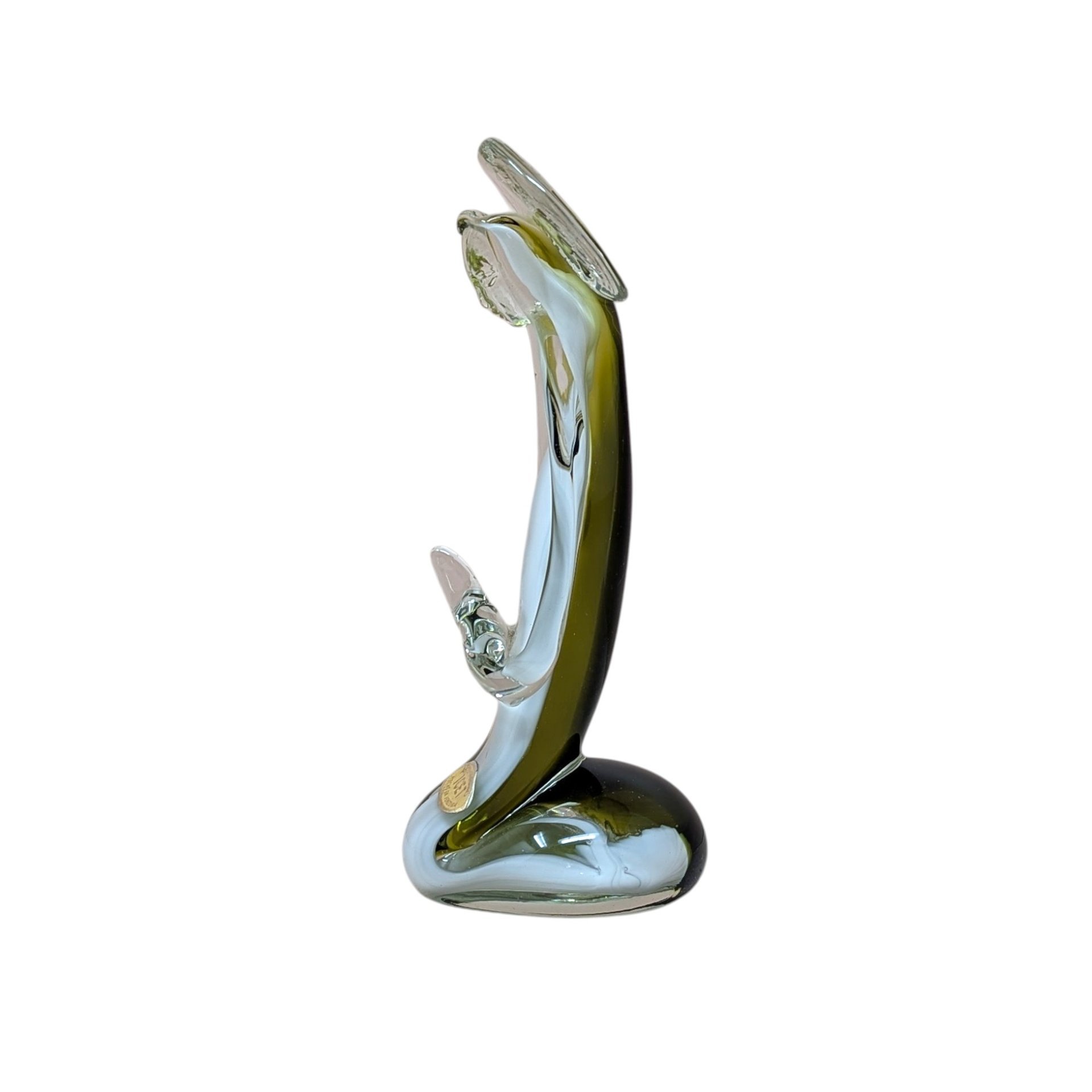 A handmade art glass figurine with a smooth, fluid silhouette. The piece features a vibrant emerald green core encased in a clear, glossy glass exterior. Its organic, elongated form tapers elegantly, reflecting light across its polished surface.