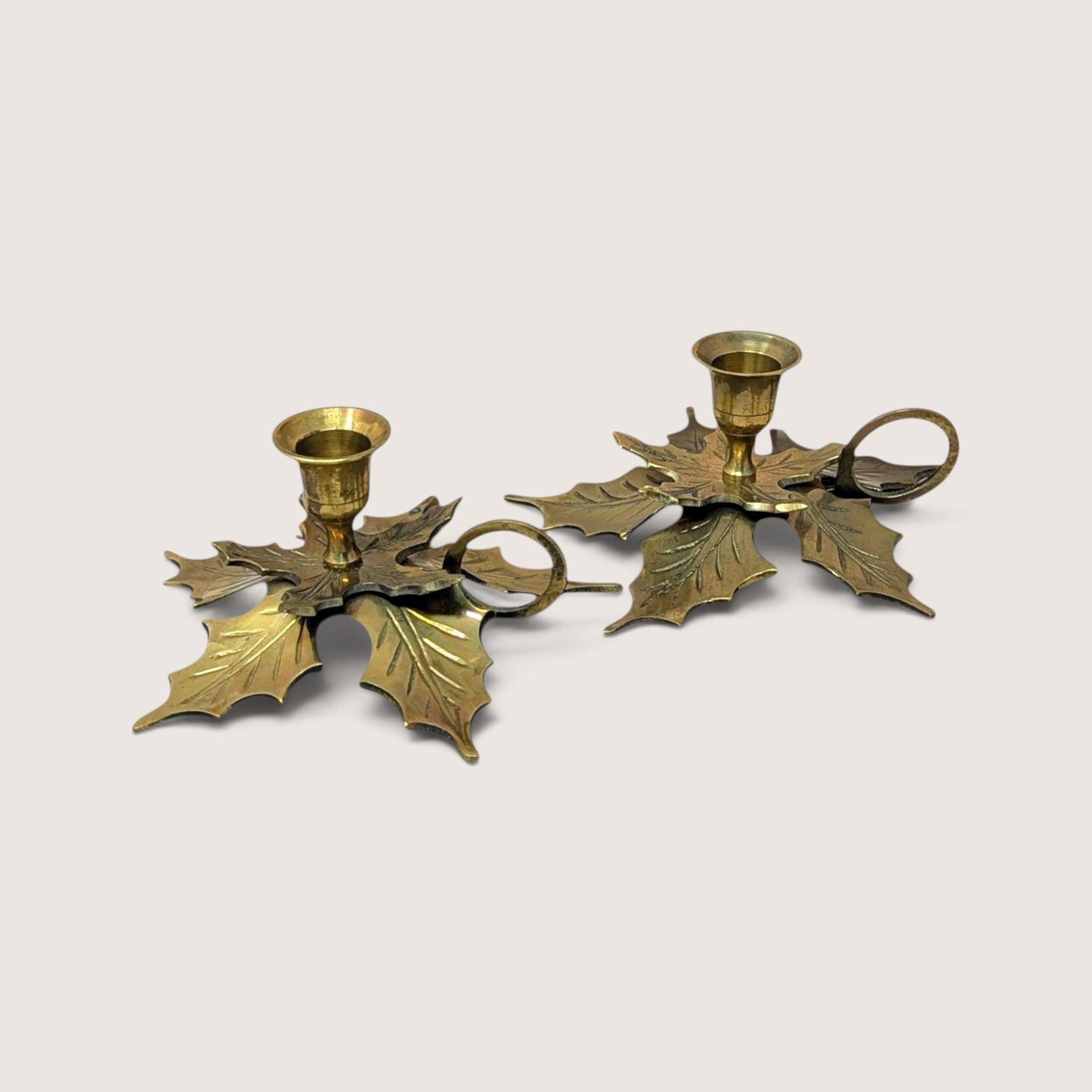 Pair of vintage brass leaf candlestick holders with finger rings made in India.