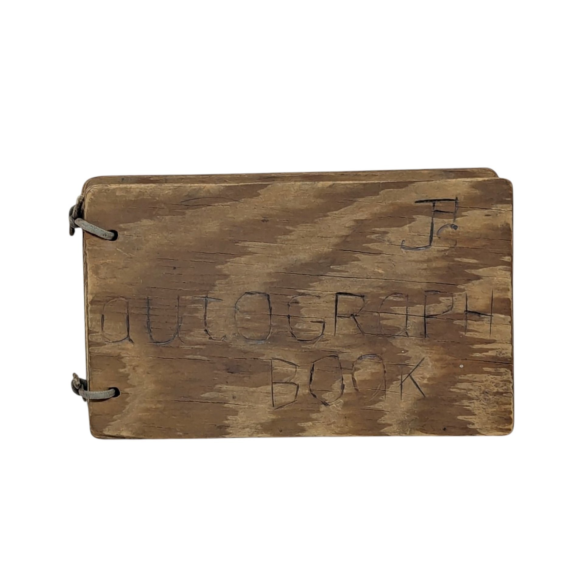 A small, rectangular autograph book with a natural wood grain cover. The words "Autograph Book" are hand-carved into the wood. Two metal rings bind the pages on the left. Rustic, weathered texture with a warm honey-oak finish.