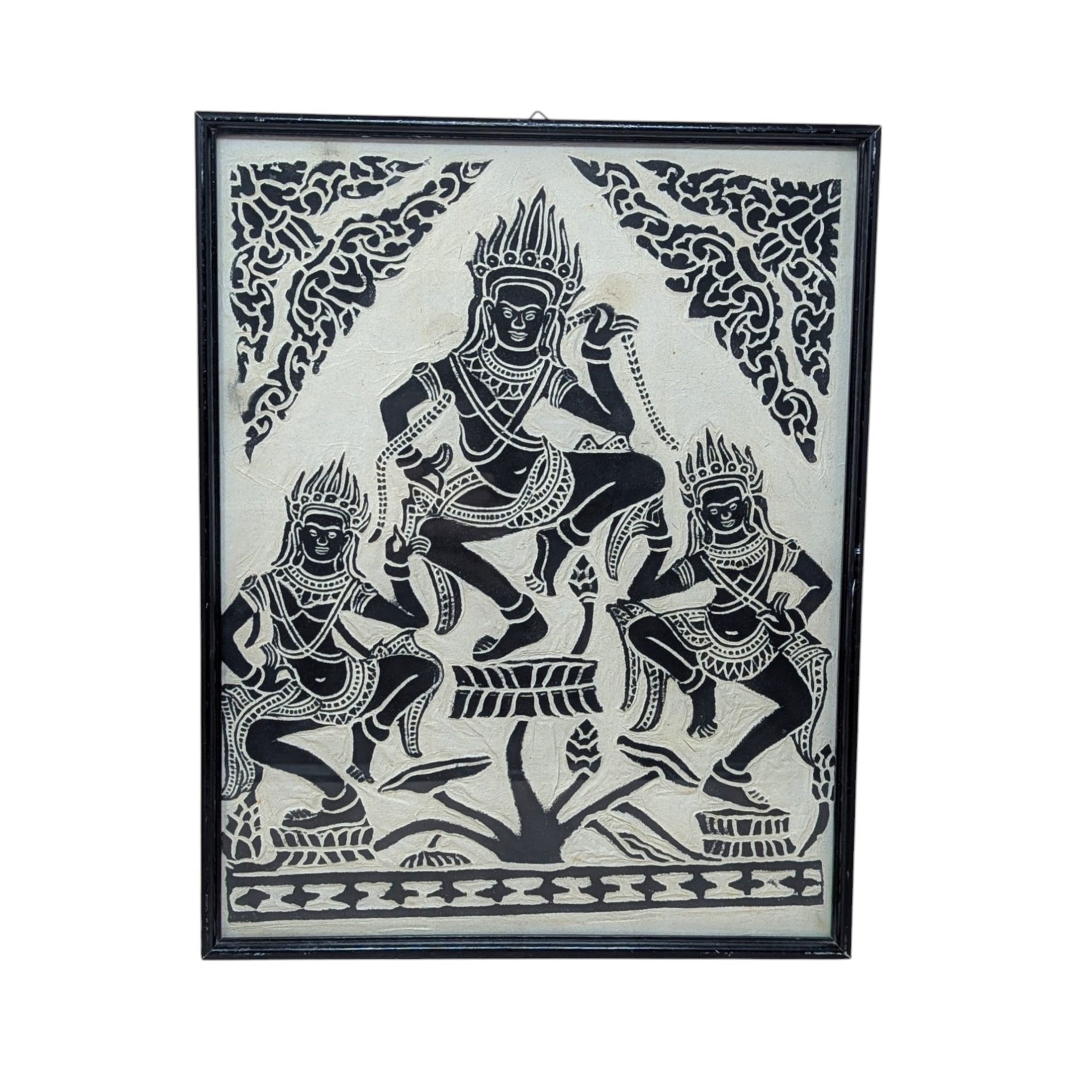 A vertical framed art piece on textured rice paper featuring three Apsara dancers in traditional Cambodian headdresses and poses. Bold black ink on a cream-white background. Framed in a minimalist black wood frame.