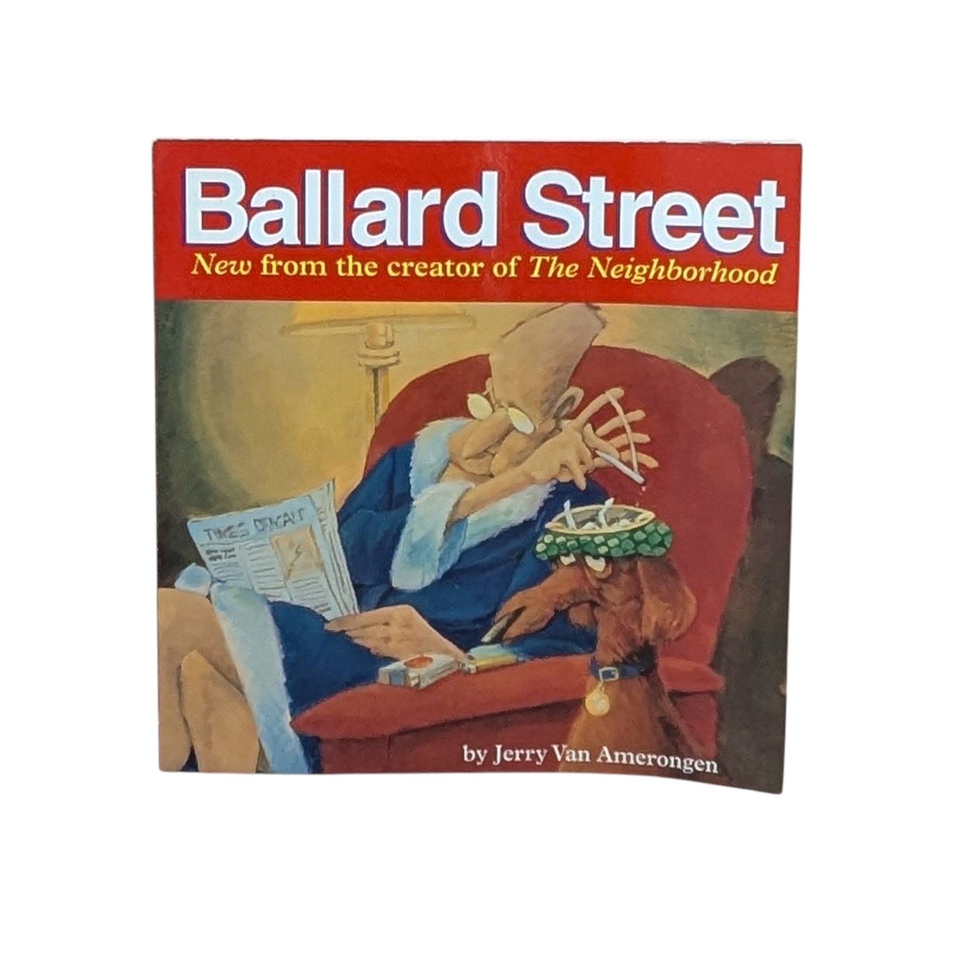 A square paperback book titled "Ballard Street" in white text on a red bar. The cover art shows an elderly man in a blue robe sitting in a red armchair, tapping ashes into a hat worn by a dog. 144 pages of cartoon illustration.