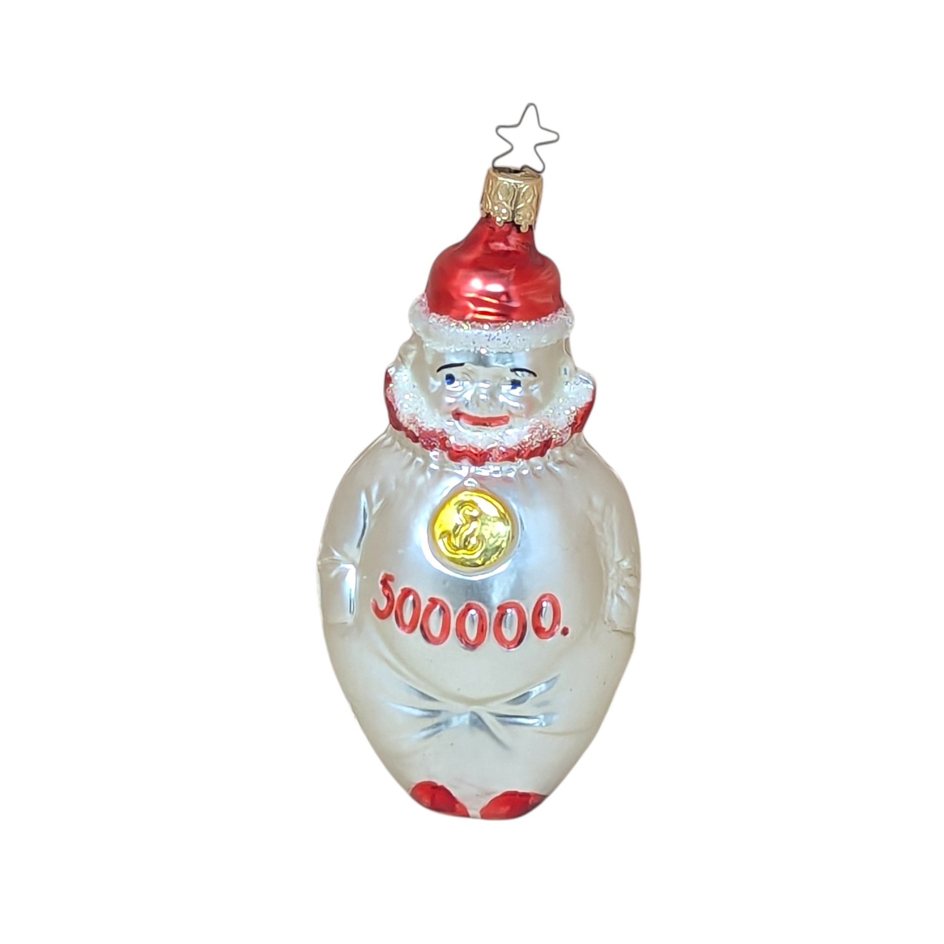 A vertical 5.5-inch blown glass clown ornament with a silvered body. The clown wears a red hat and ruff, with a gold medallion on its chest and "500,000" painted in red across the belly. Topped with a signature star-shaped metal cap.