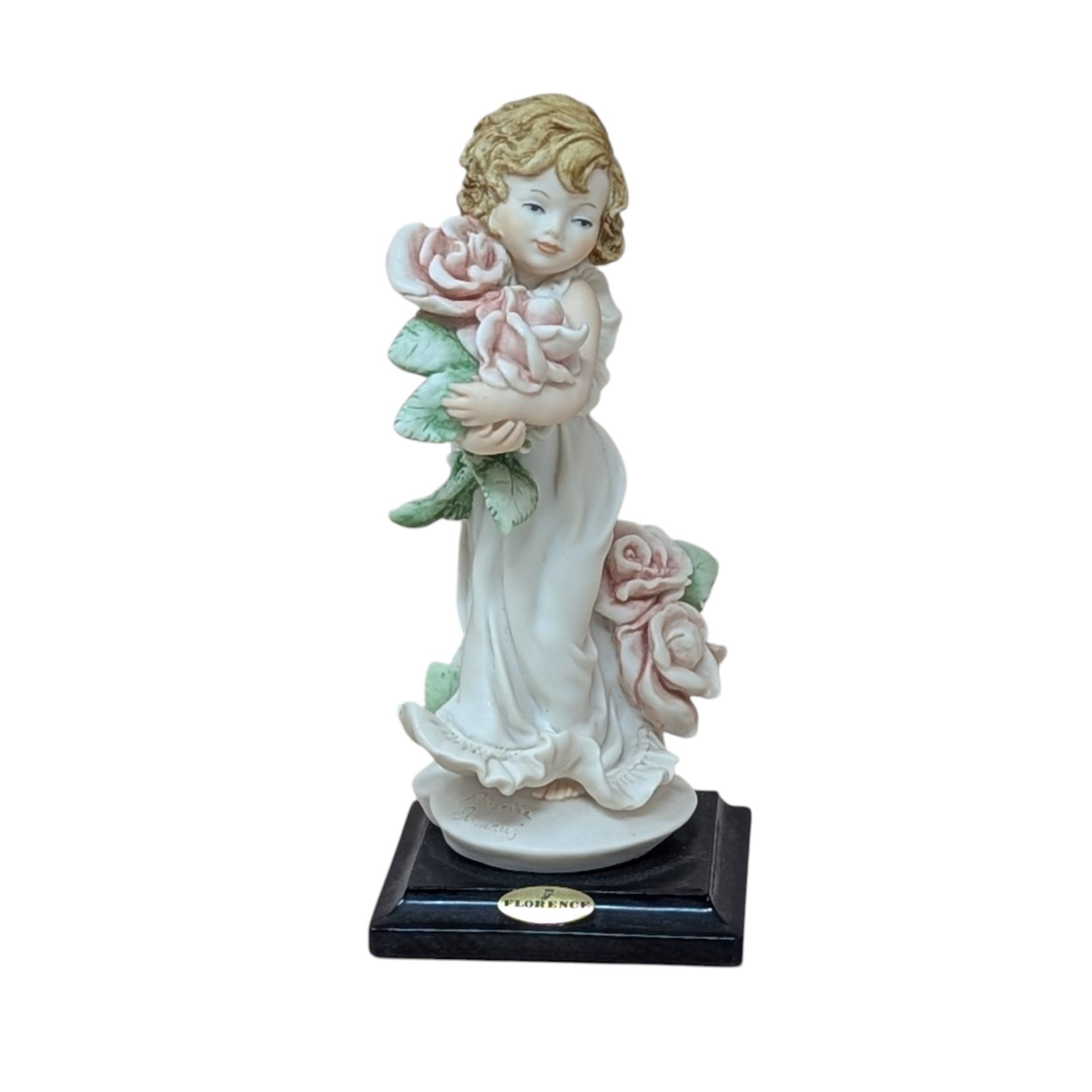 A finely detailed porcelain figurine of a young girl in a flowing white dress holding a large bouquet of pink roses. She stands on a dark wooden base with a gold Florence Giuseppe Armani plaque.