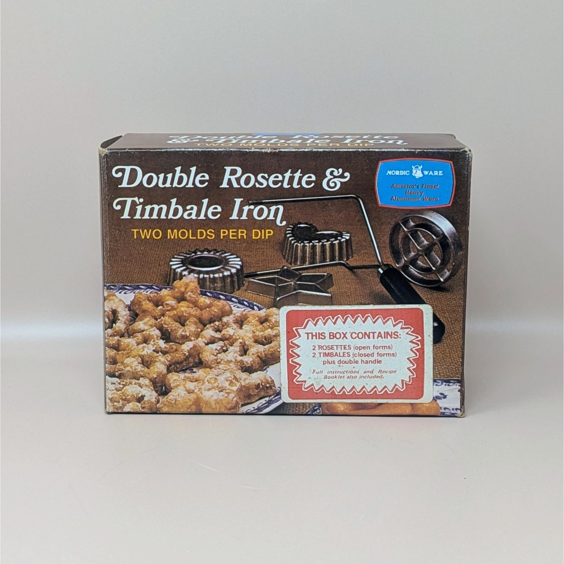 Original brown and red box for a Nordic Ware Double Rosette and Timbale Iron. The box features photos of golden fried pastries and the cast aluminum iron molds.