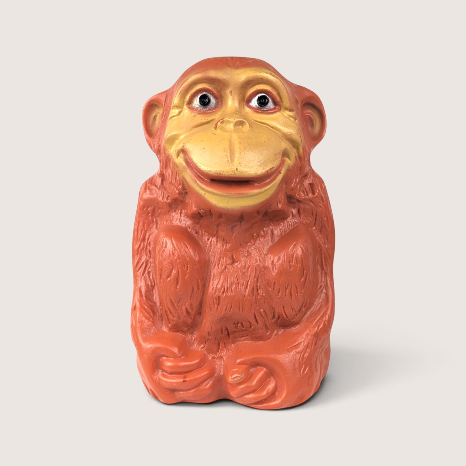 Vintage Wing Inc plastic monkey bank with expressive hand-painted details.