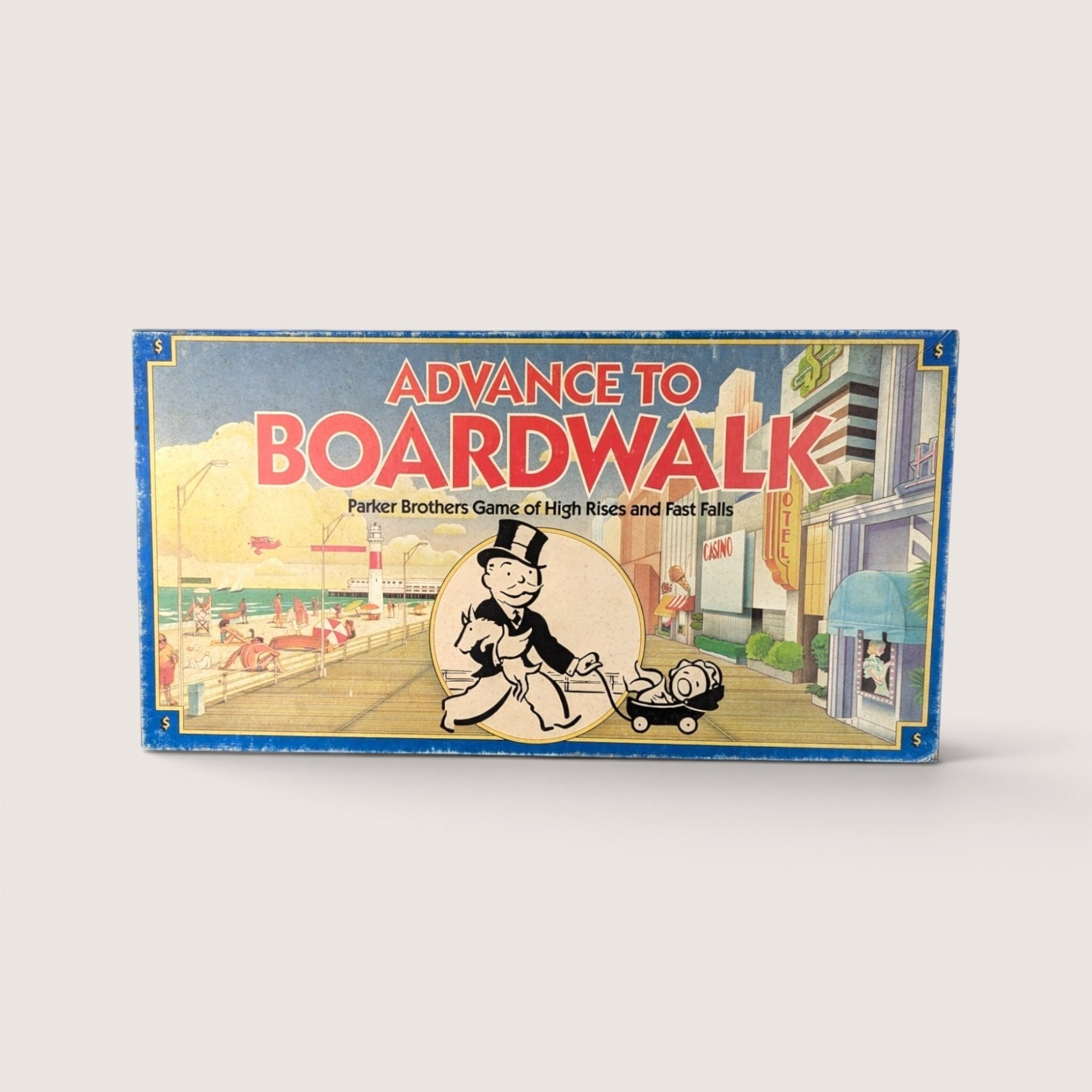 Advance to Boardwalk board game box featuring the vintage Monopoly mascot walking along an Atlantic City boardwalk scene.