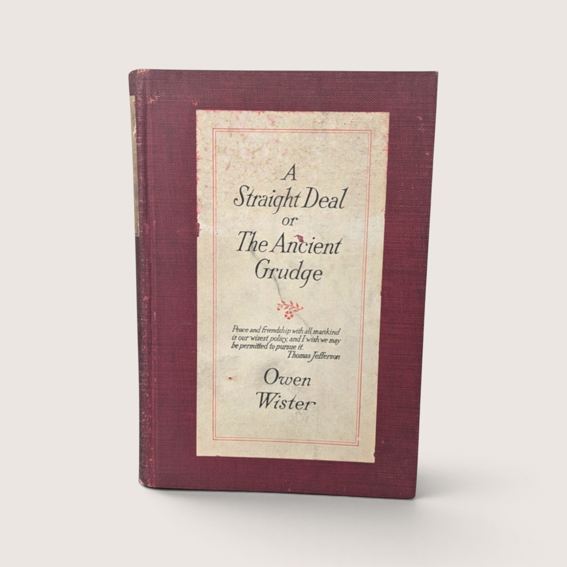 1920 A Straight Deal or The Ancient Grudge hardcover book by Owen Wister published by The Macmillan Company with a red cloth binding.