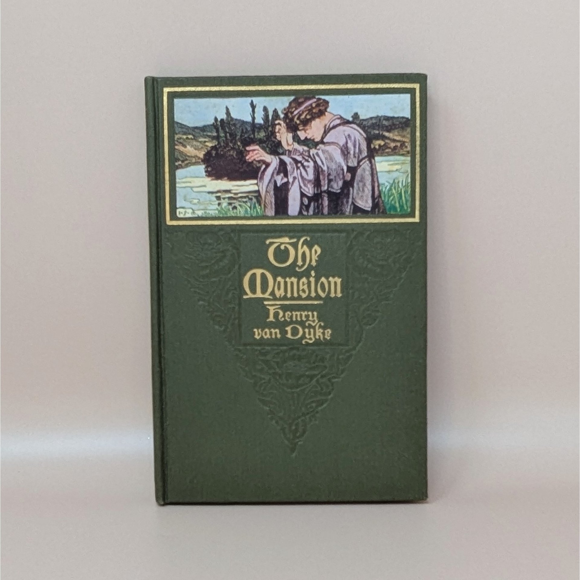 A green cloth-bound hardcover book featuring a color illustration of a man in robes looking over a landscape, with gilded title text for The Mansion by Henry Van Dyke against a neutral background.