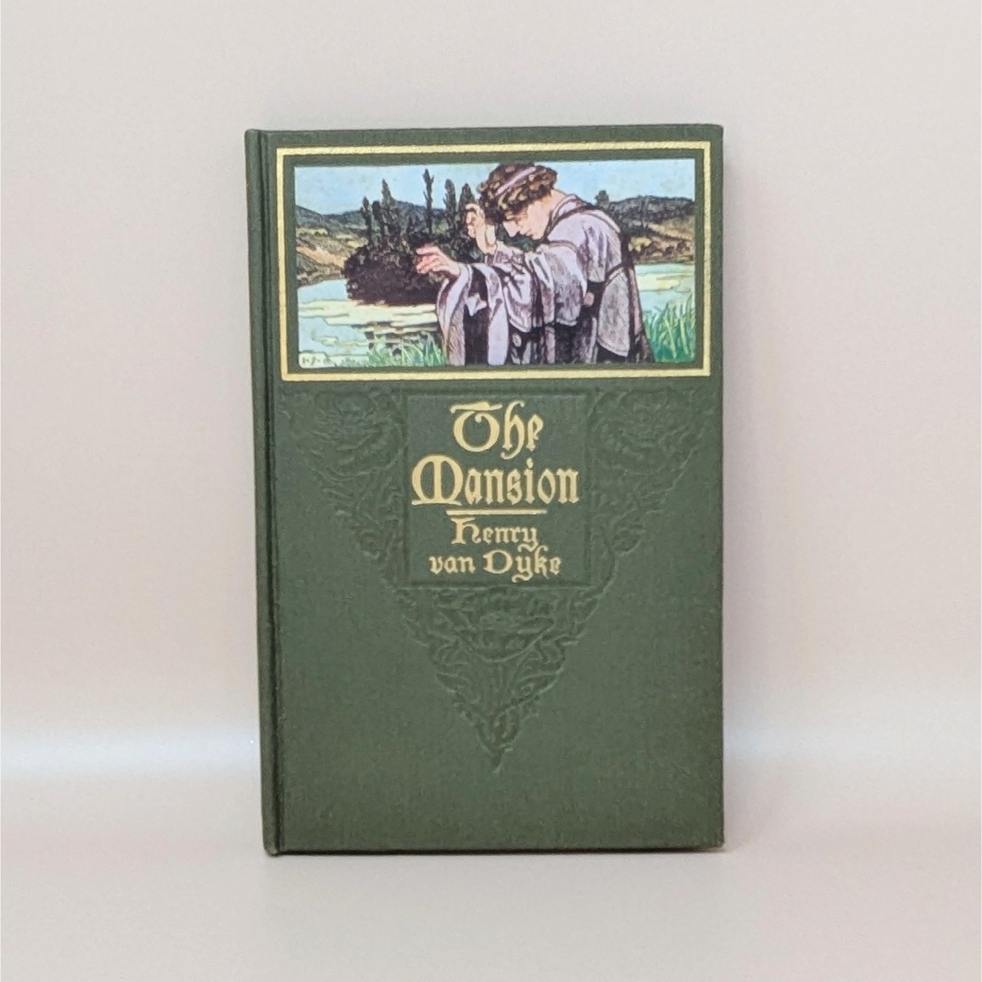 A green cloth-bound hardcover book featuring a color illustration of a man in robes looking over a landscape, with gilded title text for The Mansion by Henry Van Dyke against a neutral background.