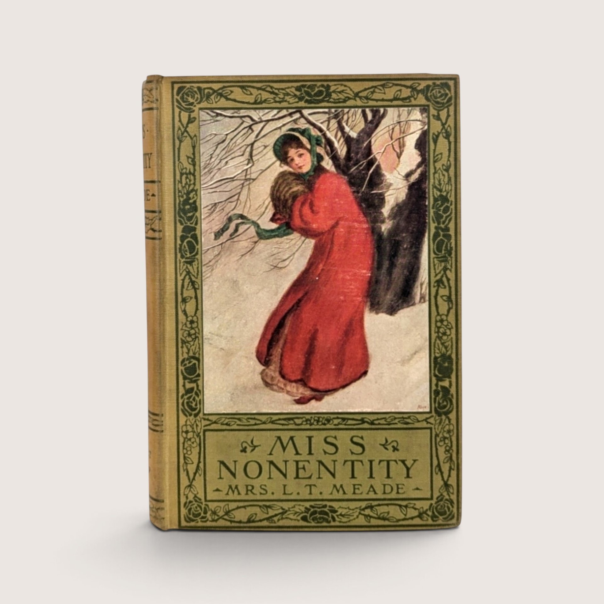 Antique Miss Nonentity hardcover book by Mrs. L.T. Meade with a decorative green floral border and winter illustration inset.