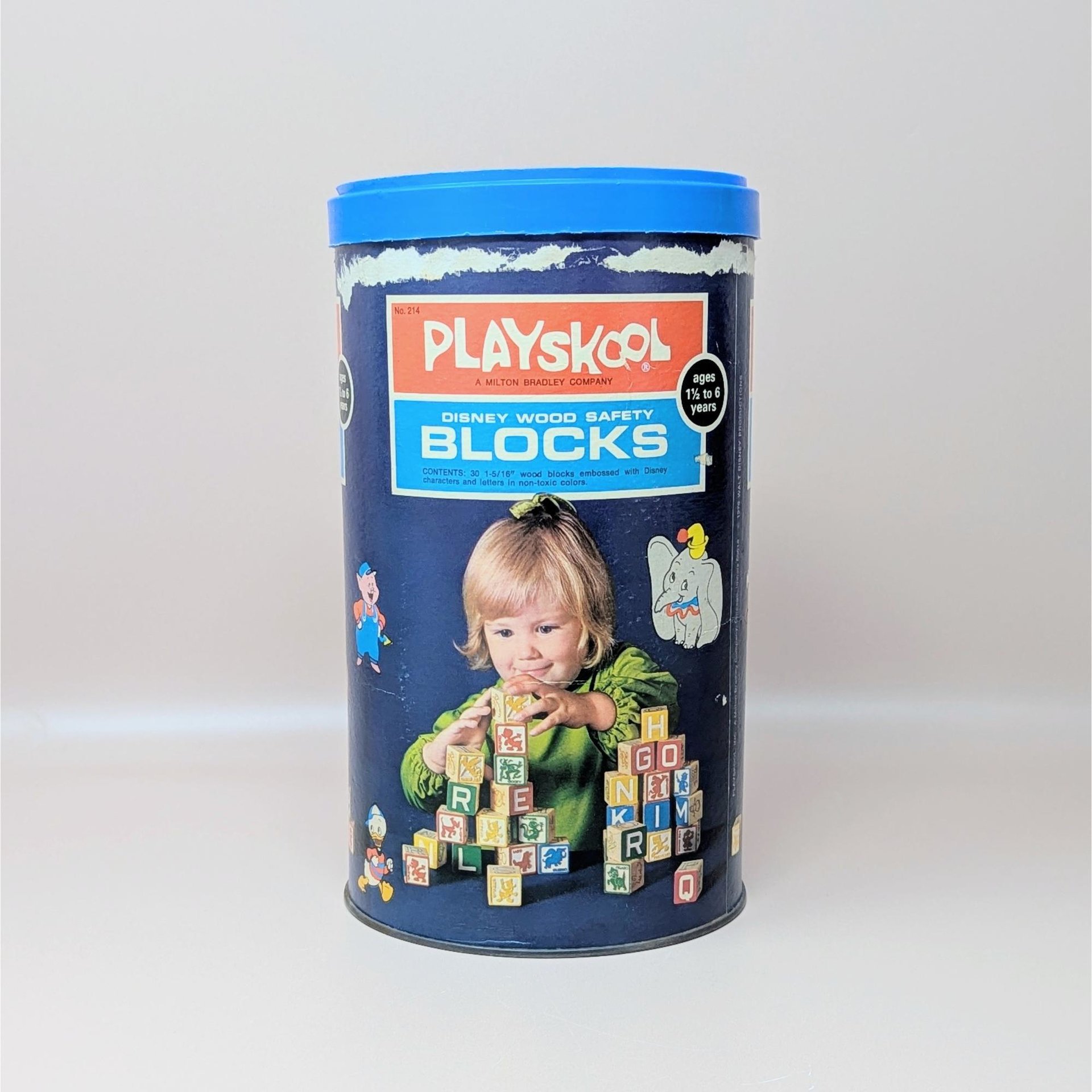 A vintage navy blue Playskool canister for Disney Wood Safety Blocks featuring a child playing with blocks and various Disney character graphics
