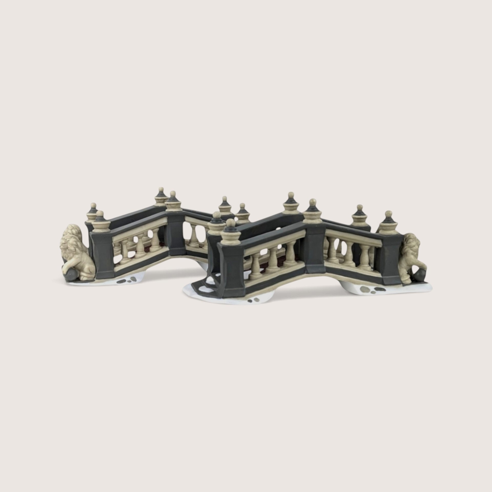 A pair of Department 56 Heritage Village ceramic Lionhead Bridges featuring gray arches and lion statues.