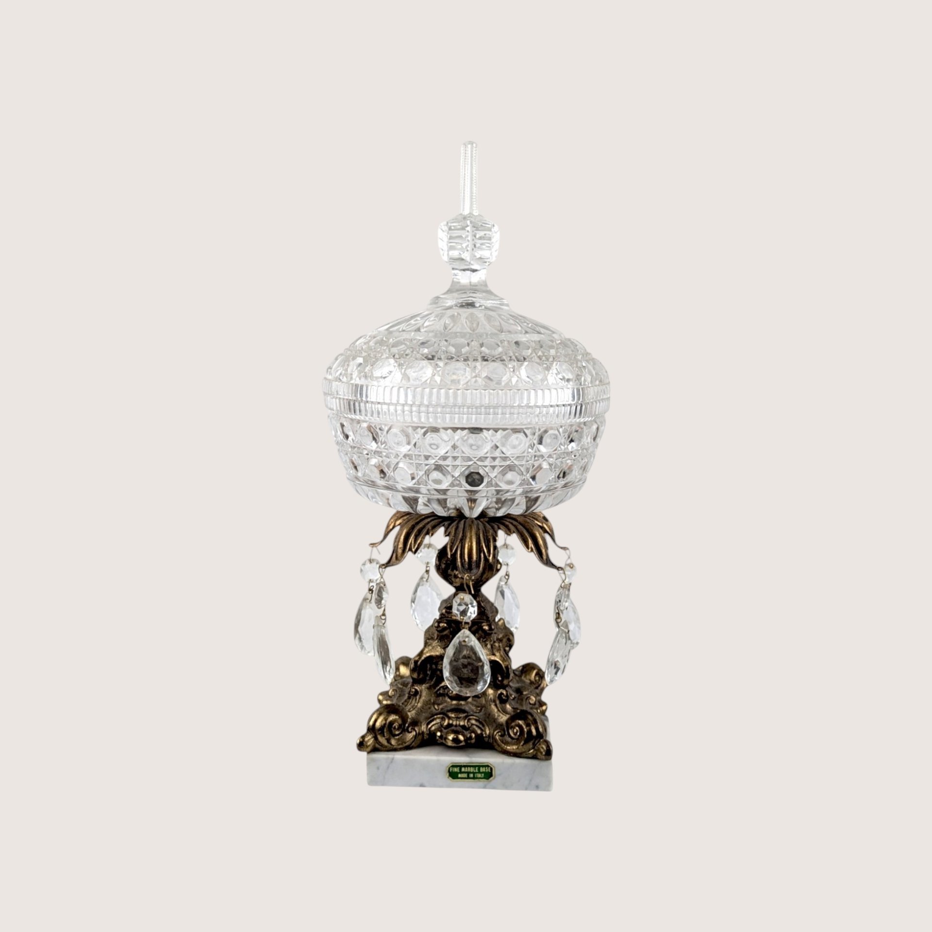 Vintage crystal covered candy dish on a brass pedestal with acrylic prisms and a white Italian marble base.