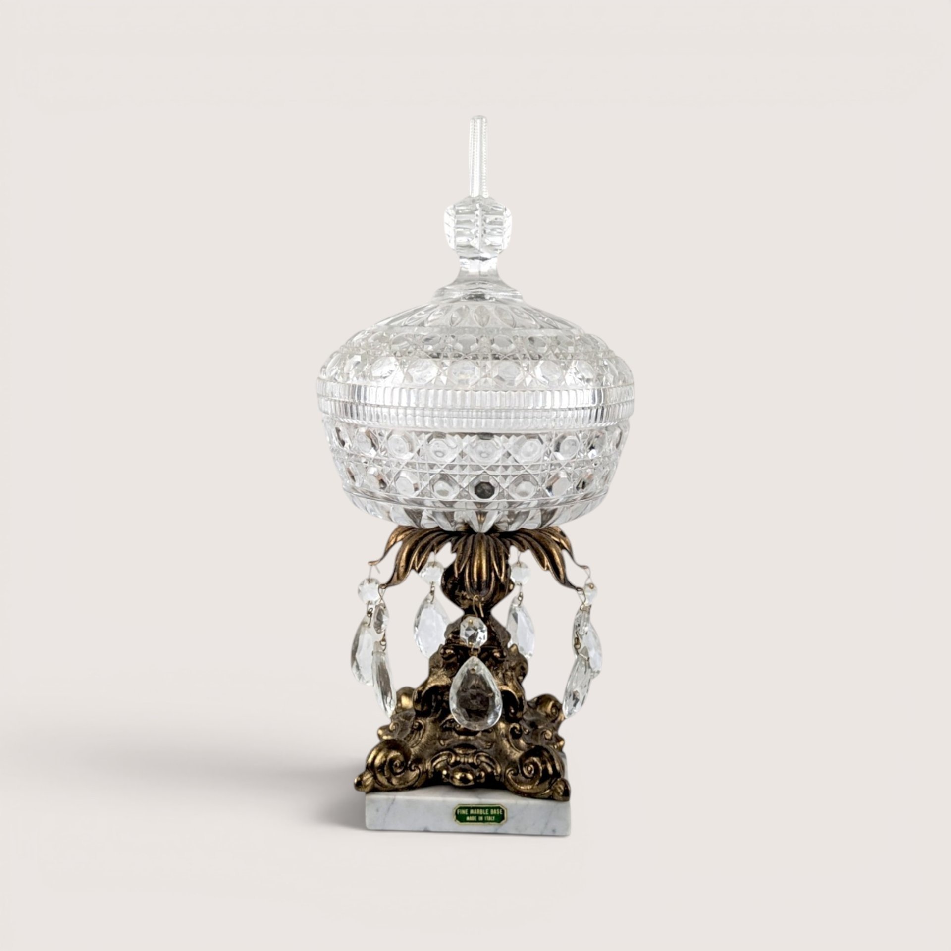 Vintage crystal covered candy dish on a brass pedestal with acrylic prisms and a white Italian marble base.