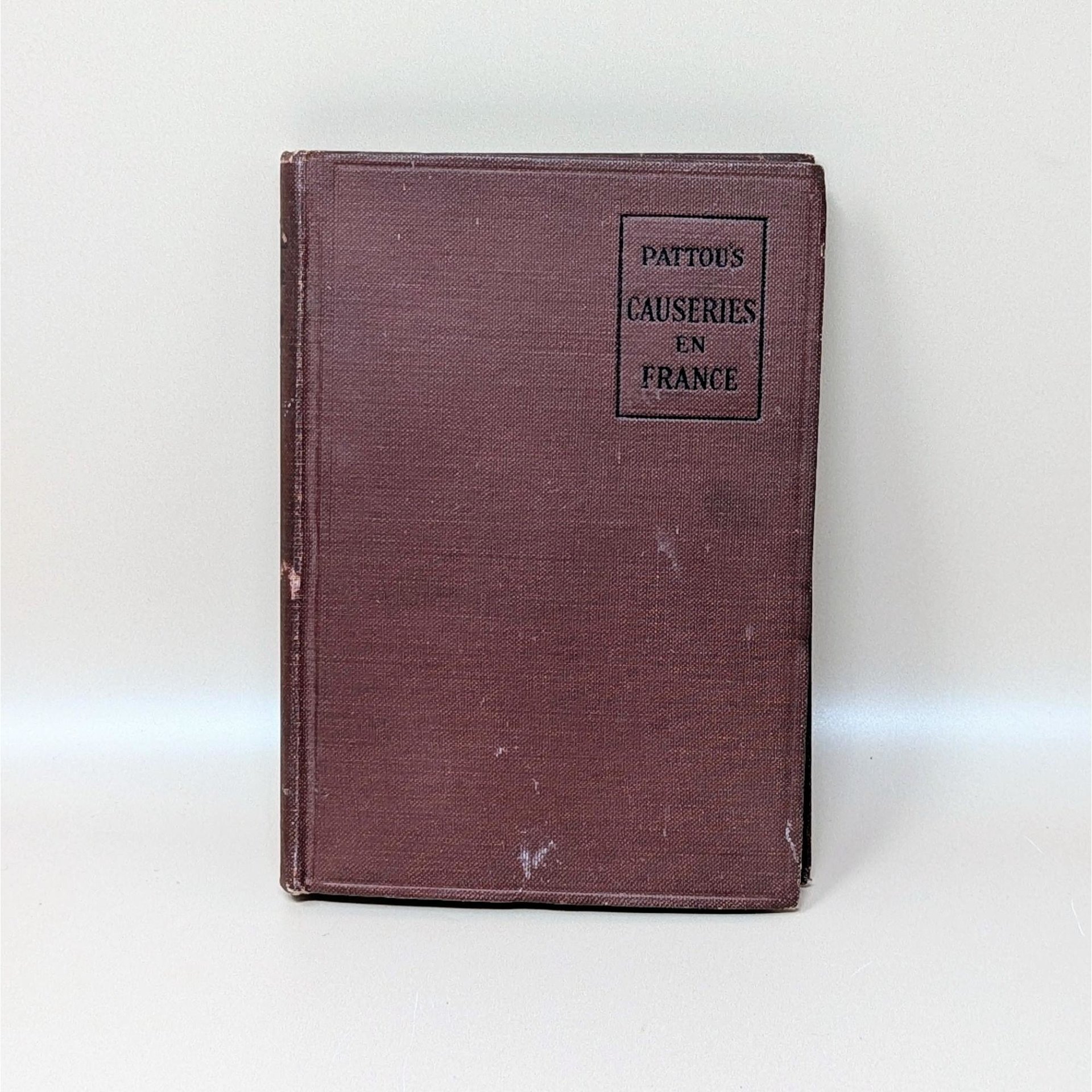 A 1918 hardcover book titled Causeries en France with a dark burgundy textured cloth cover and black stamped lettering
