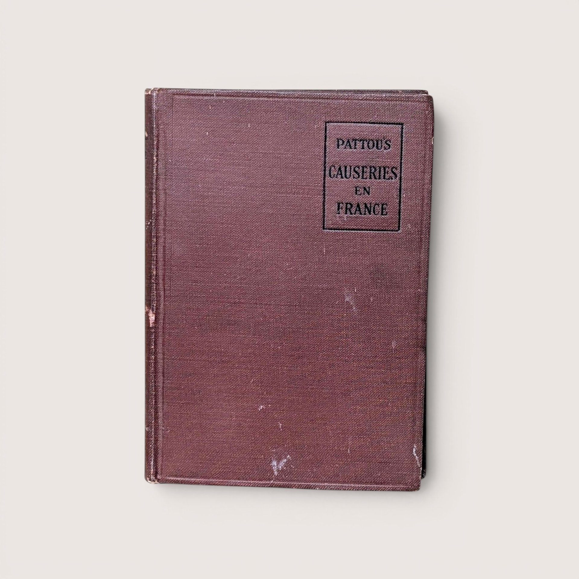 An antique brown cloth book cover titled "Pattou's Causeries en France," centered on a beige background.