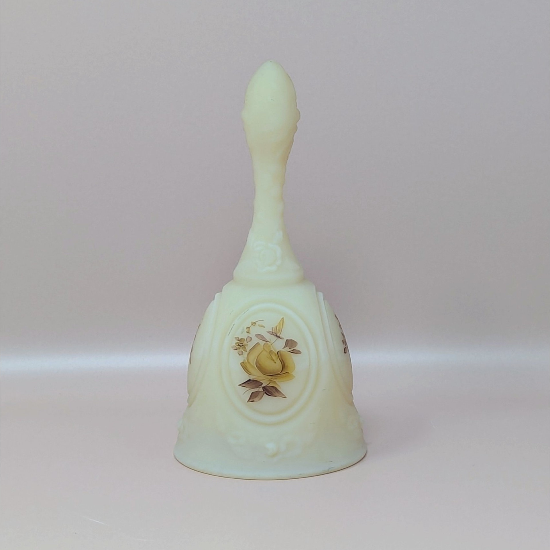 A vintage pale yellow satin glass bell featuring a handpainted brown and tan chocolate rose medallion