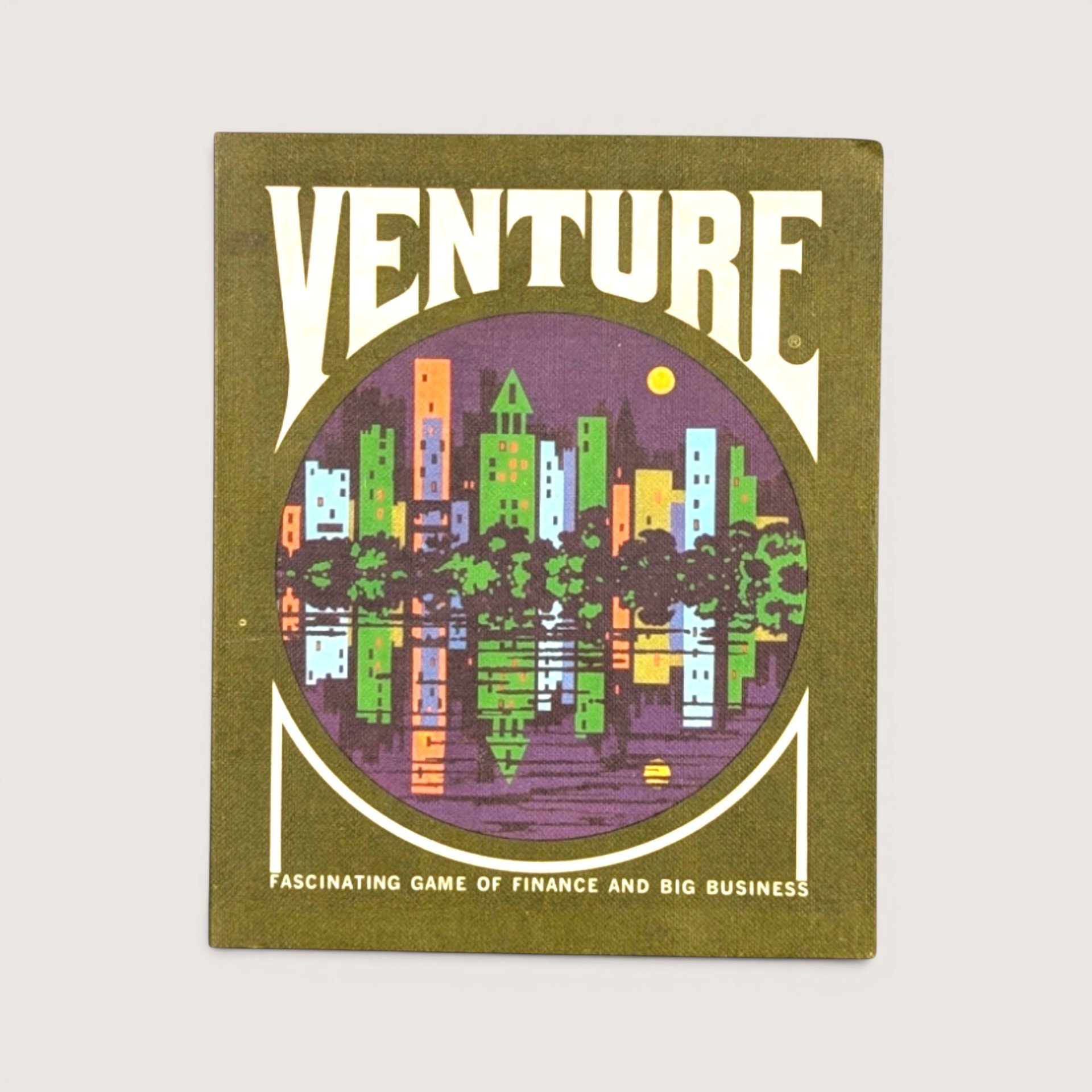 Vintage Venture game box in olive green featuring a circular illustration of a colorful city skyline water reflection.