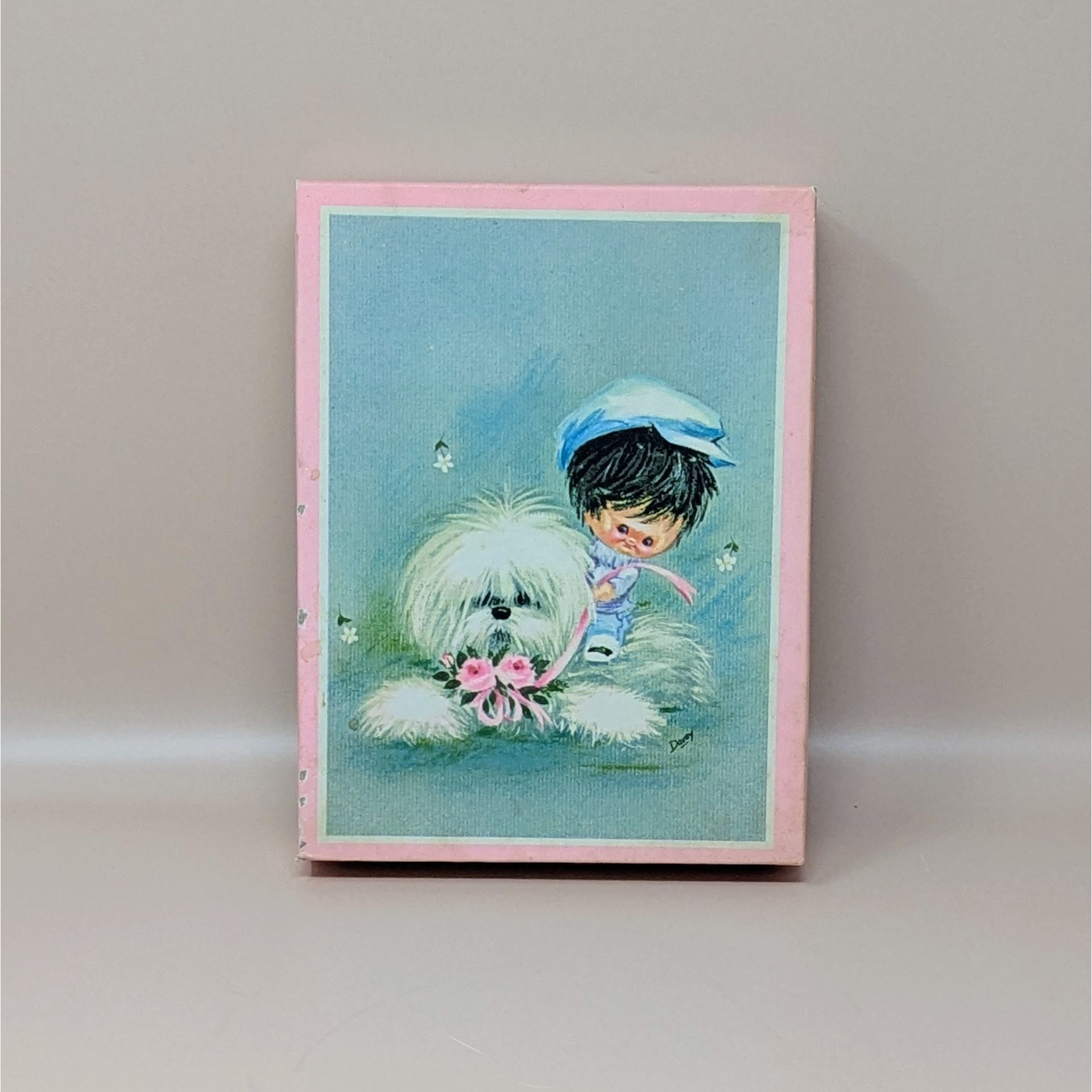 Box of vintage 1960s Darcy greeting cards featuring a big eye girl in a blue hat with a fluffy white dog and pink flowers