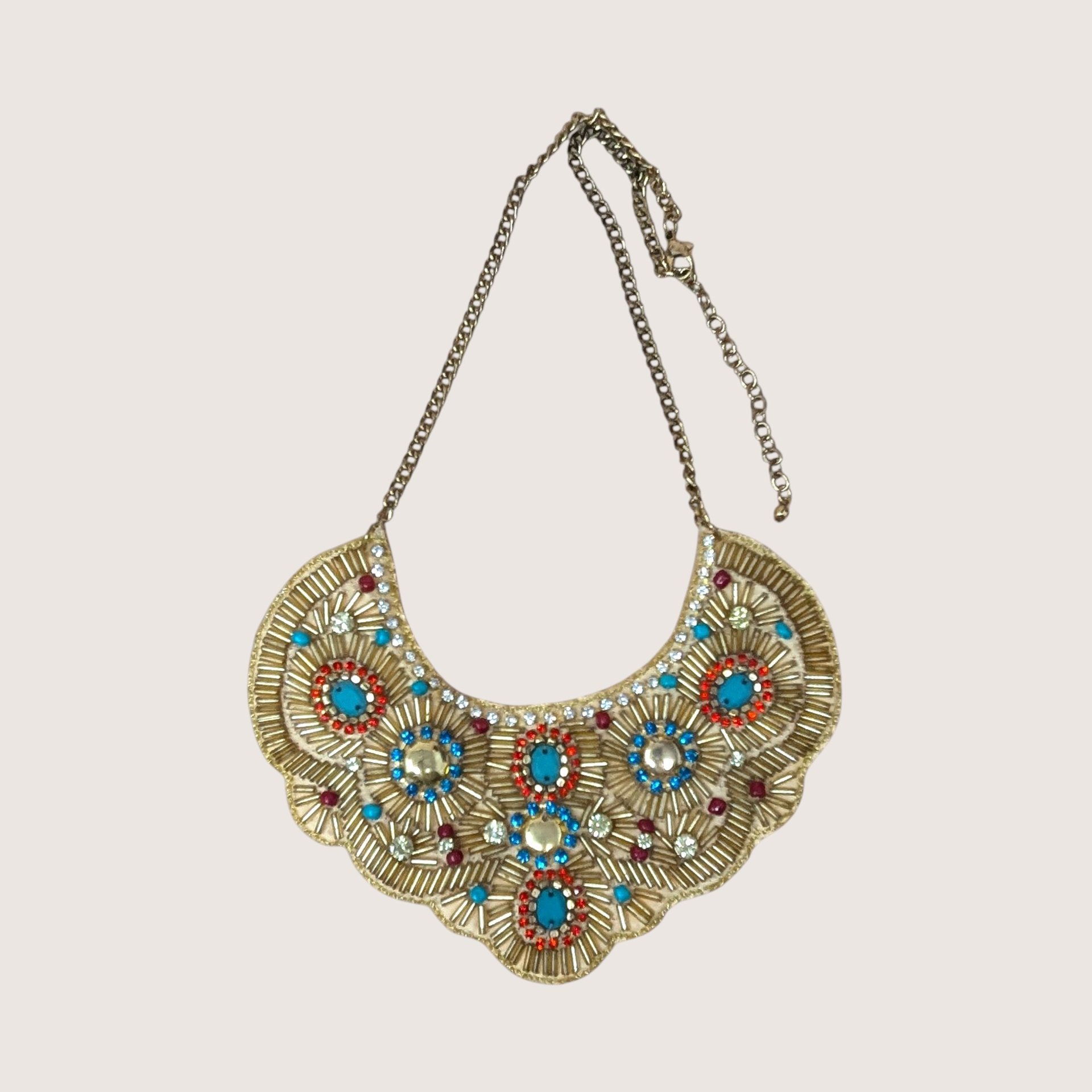Intricate gold beaded bib necklace featuring turquoise, red, and blue accents with clear rhinestones.