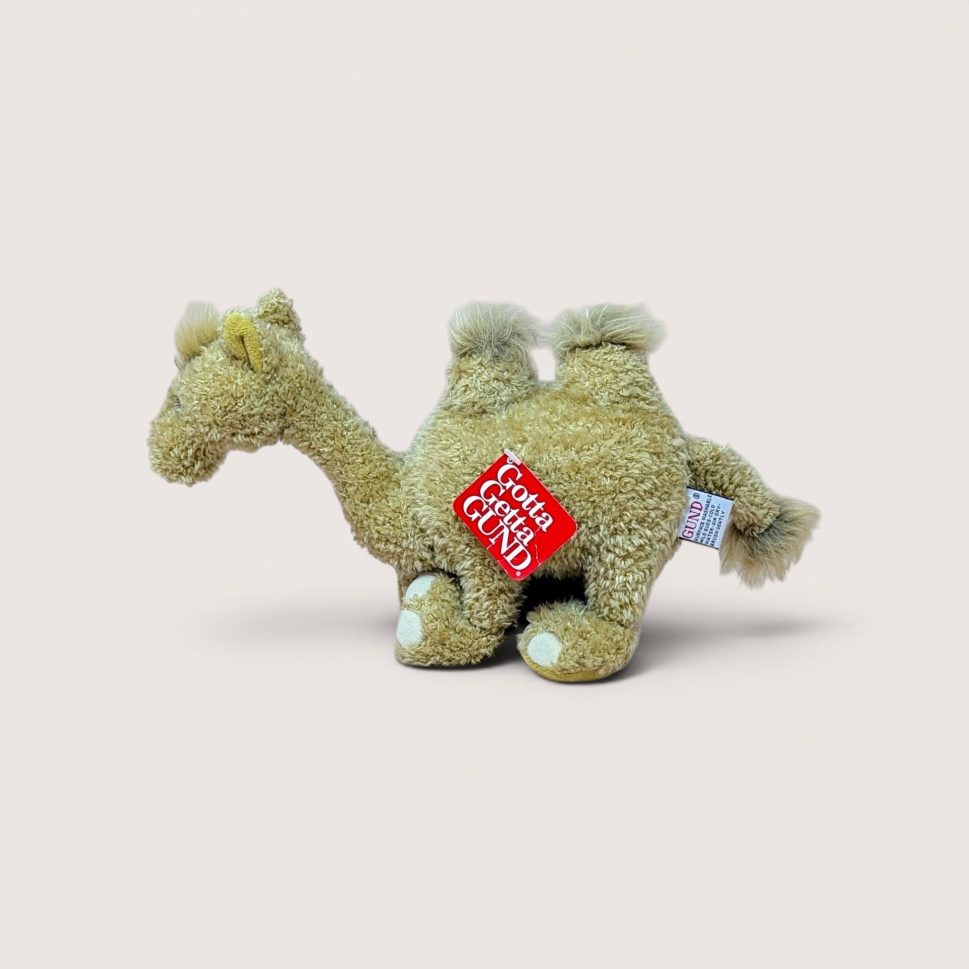 A vintage small Gund Lumpy the Camel plush stuffed animal standing upright on a plain background.