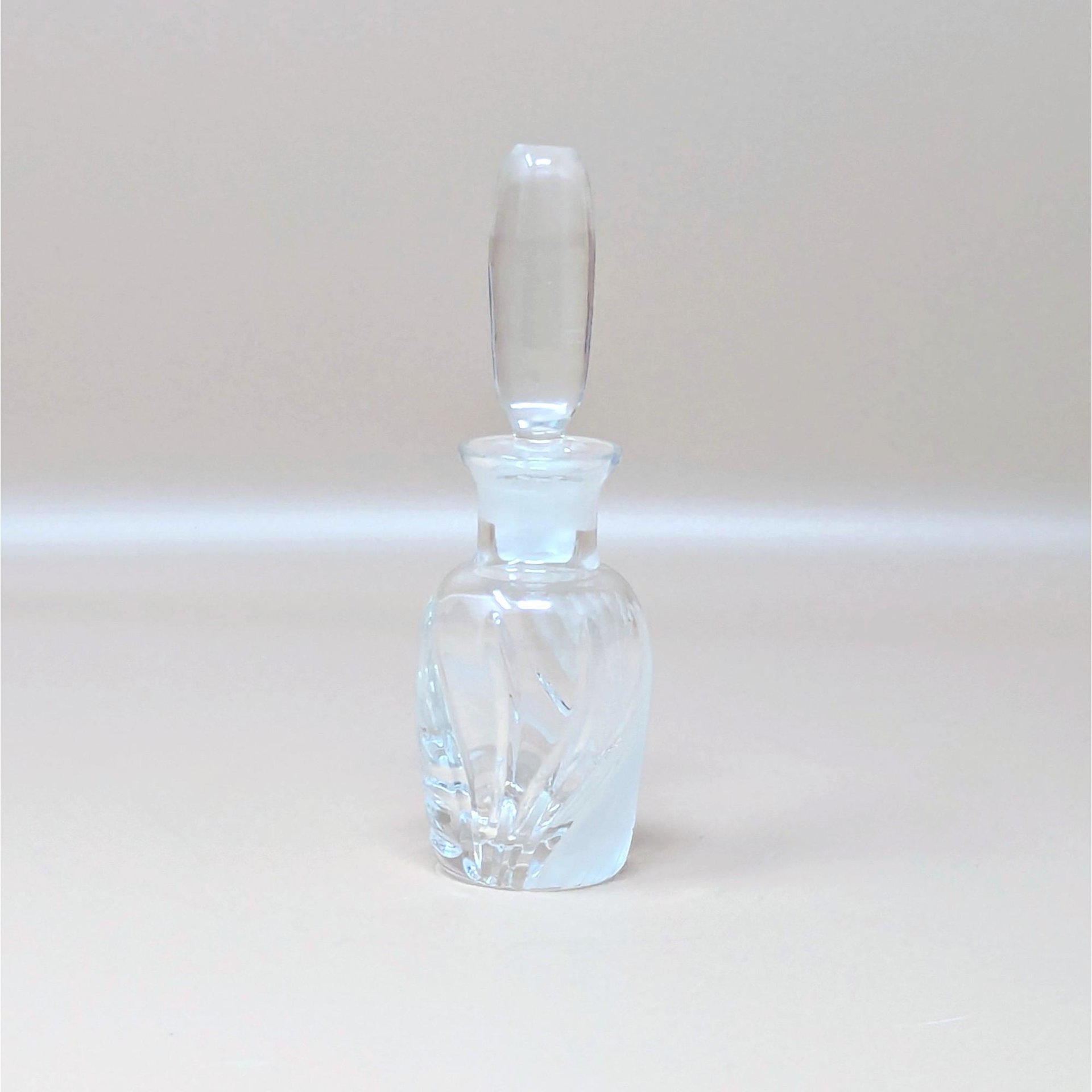 A vintage Lenox glass perfume bottle with the iconic Windswept frosted swirl pattern. The bottle features a tall, smooth clear stopper and is photographed against a neutral dune background.