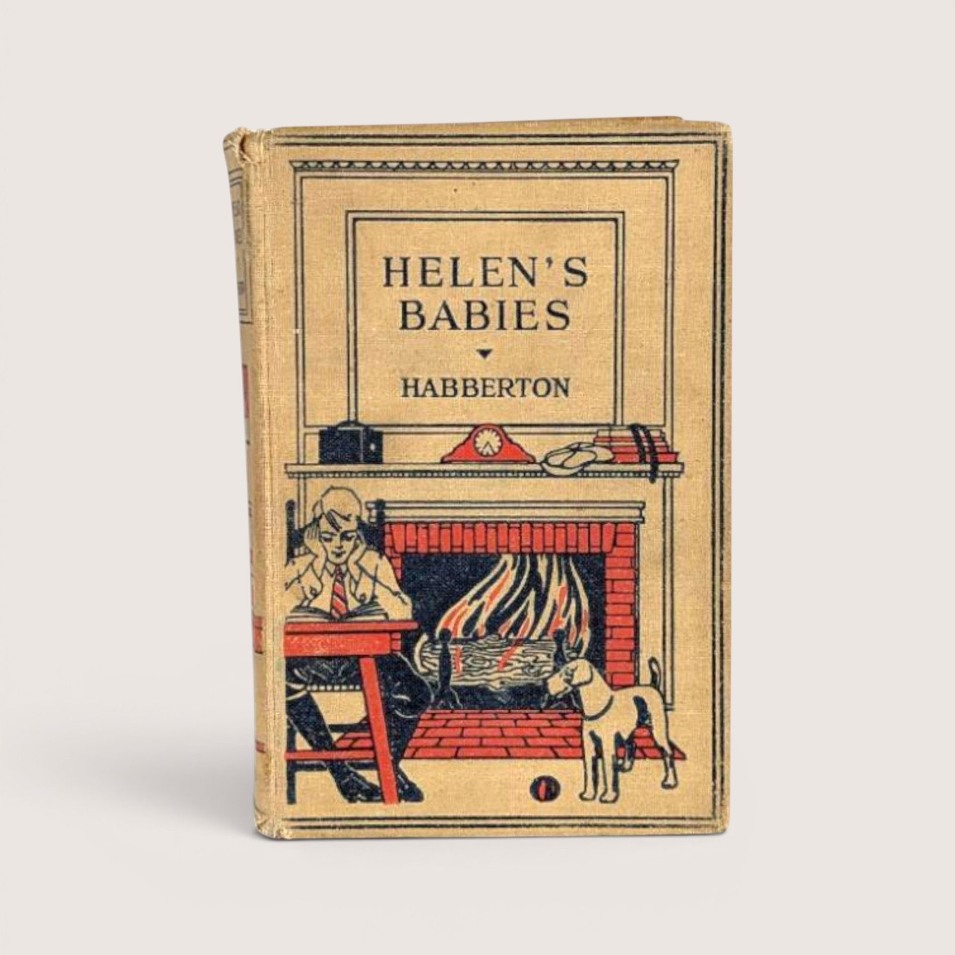 Antique Helen's Babies hardcover book featuring an illustration of a person reading by a fireplace with a dog.