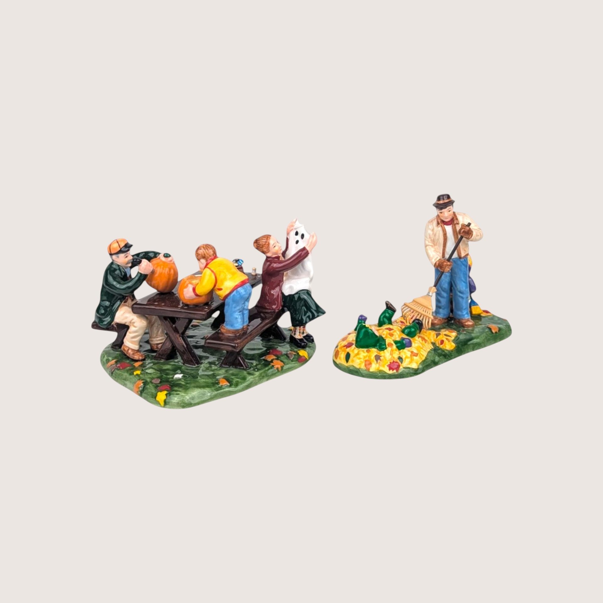 Department 56 ceramic Halloween figurine set featuring a family carving pumpkins and raking leaves.