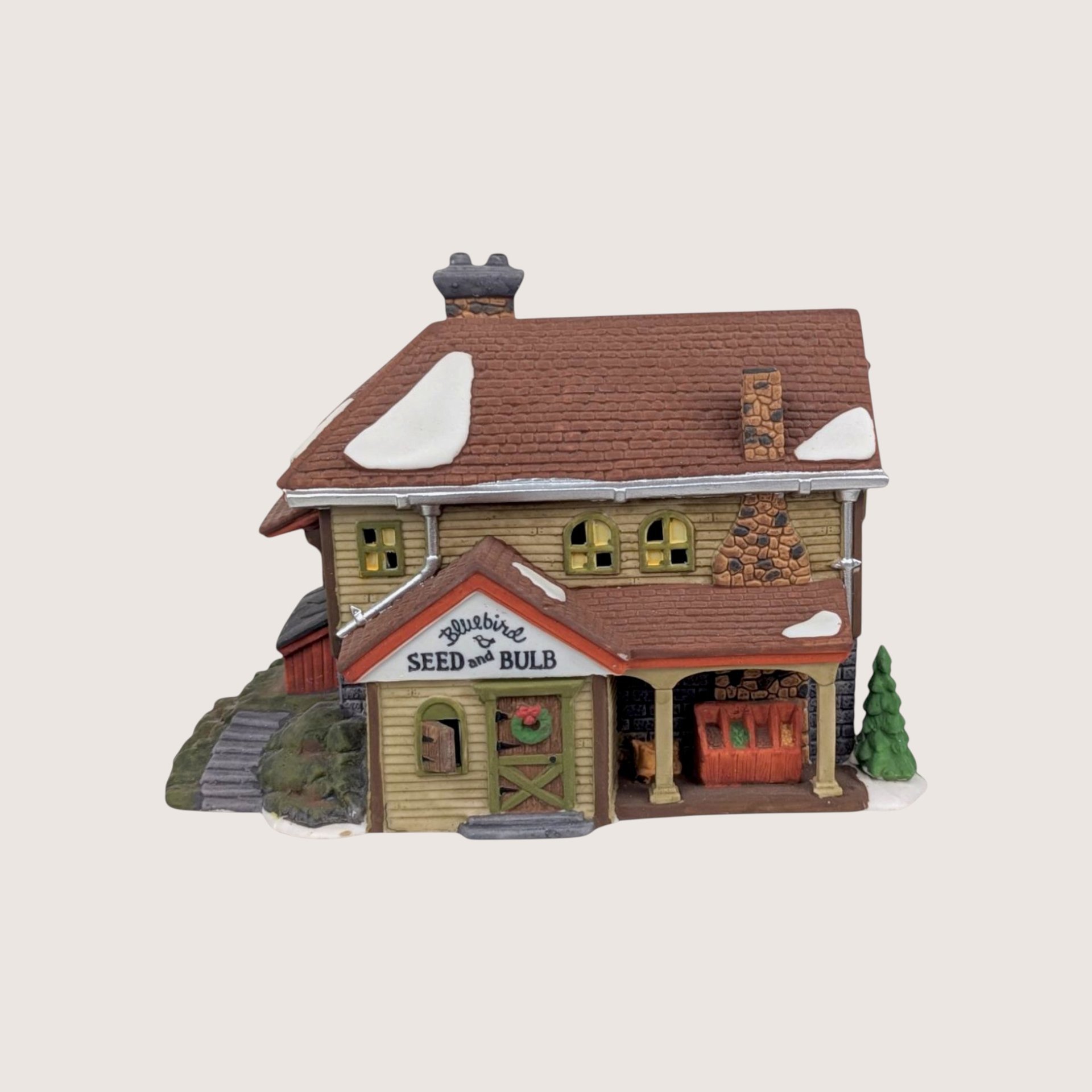 Vintage 1992 Department 56 New England Village Bluebird Seed and Bulb porcelain lit building with a side porch.