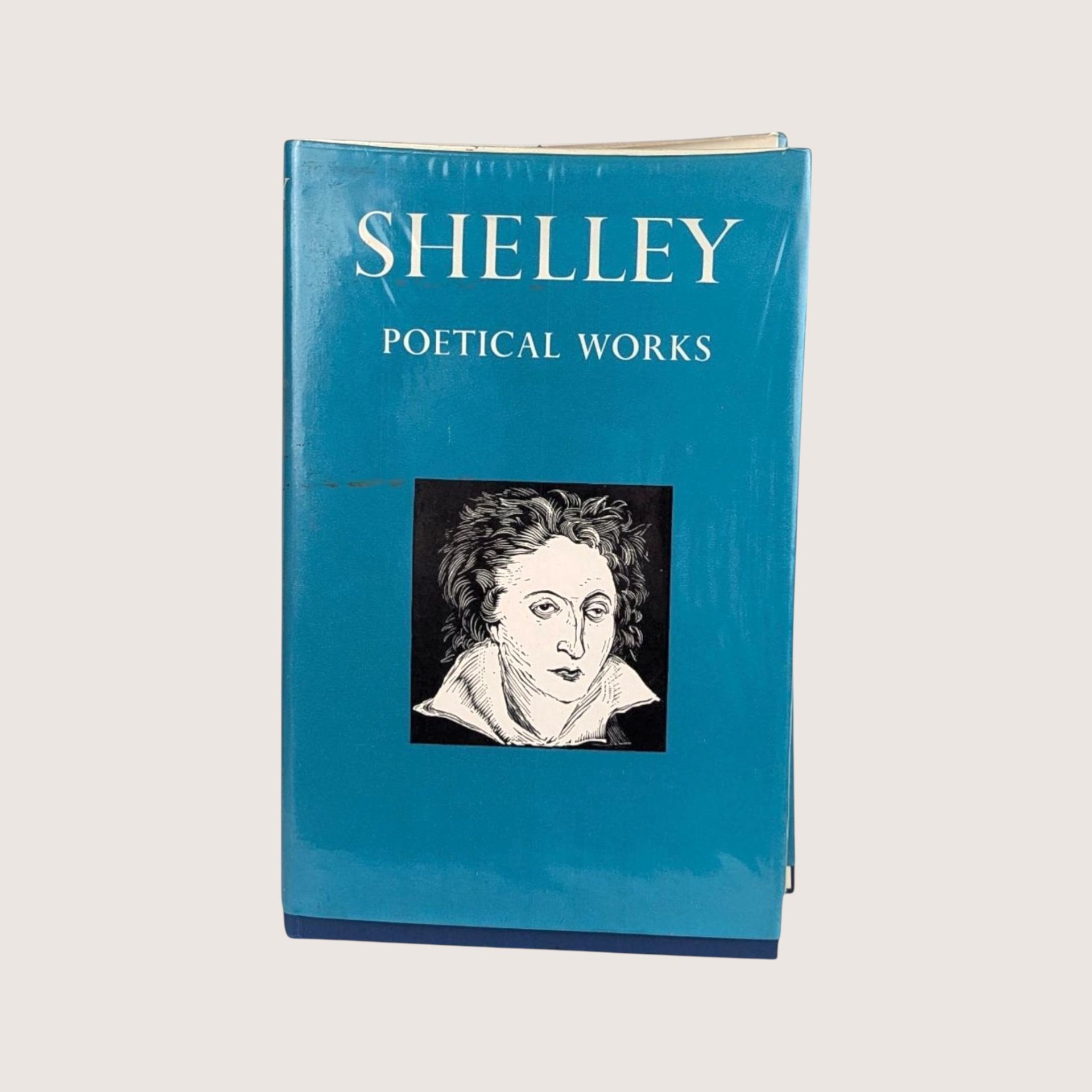 A vintage 1967 Oxford University Press edition of Shelley Poetical Works with a teal blue dust jacket featuring a portrait.