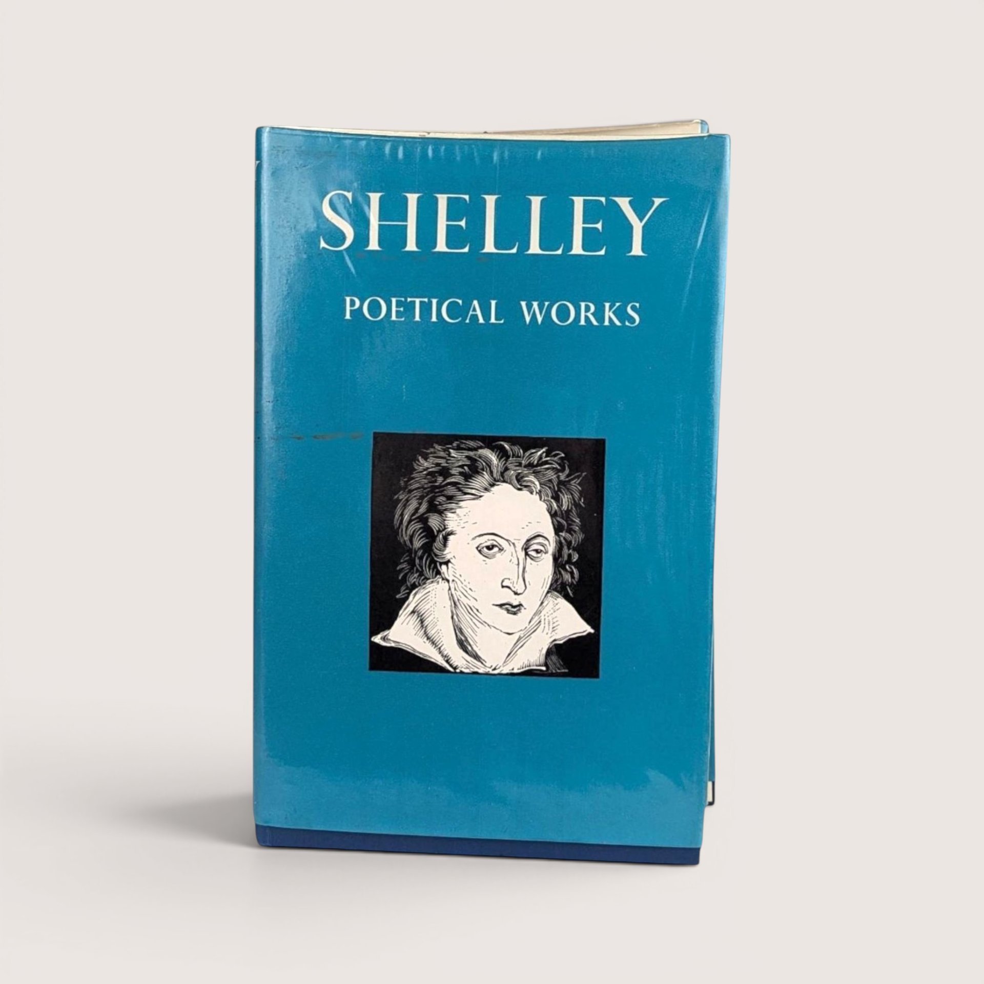 A vintage 1967 Oxford University Press edition of Shelley Poetical Works with a teal blue dust jacket featuring a portrait.