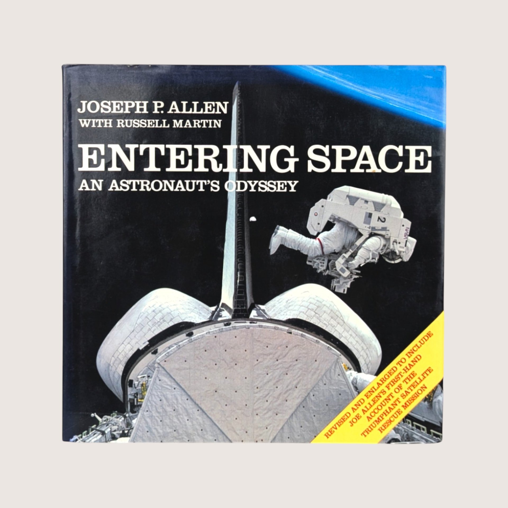 A vintage hardcover copy of Entering Space An Astronaut's Odyssey by Joseph P Allen featuring a space shuttle illustration.