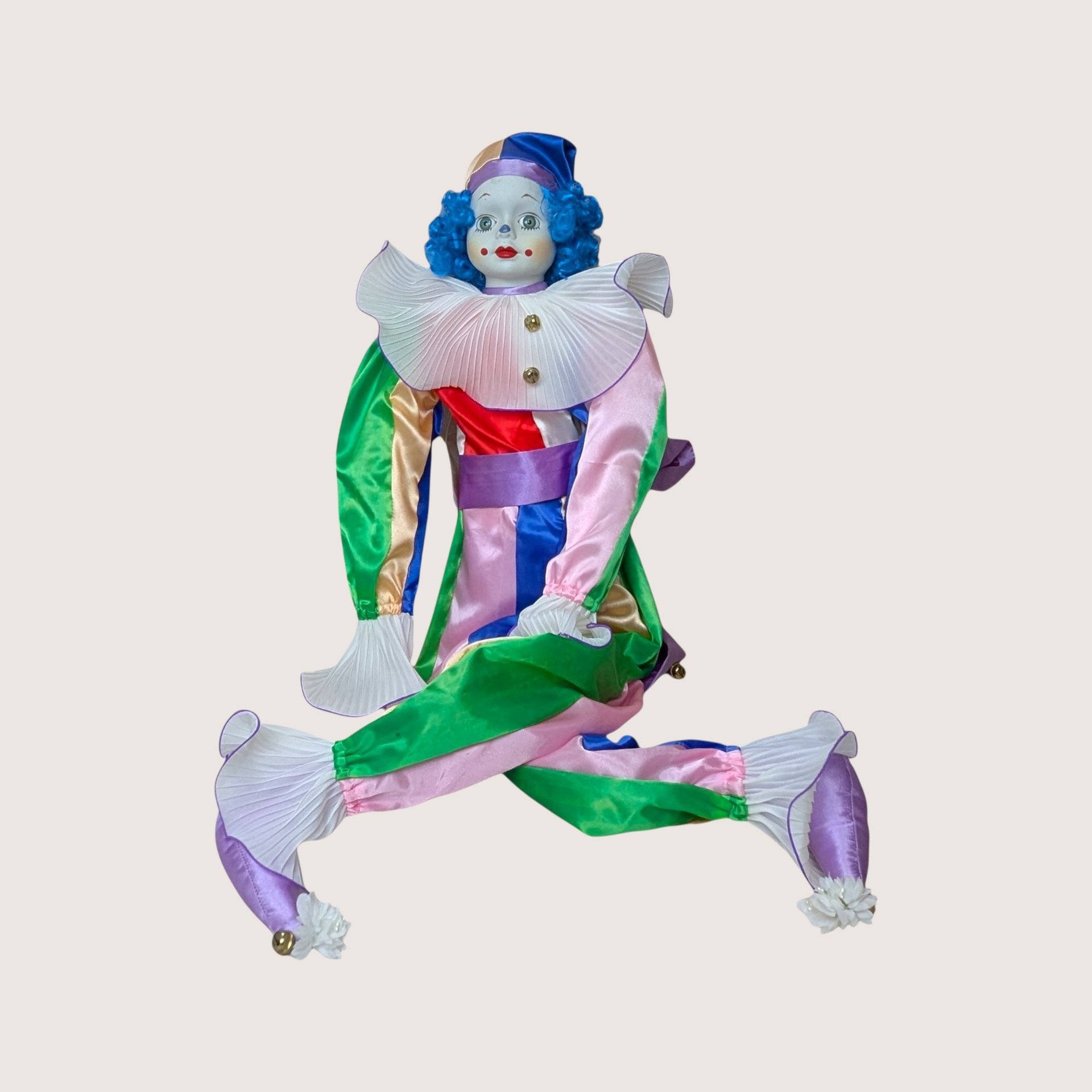 A vintage Bette Ball Victoria Ashlea Originals porcelain clown doll named Jody with blue hair and a colorful satin outfit.