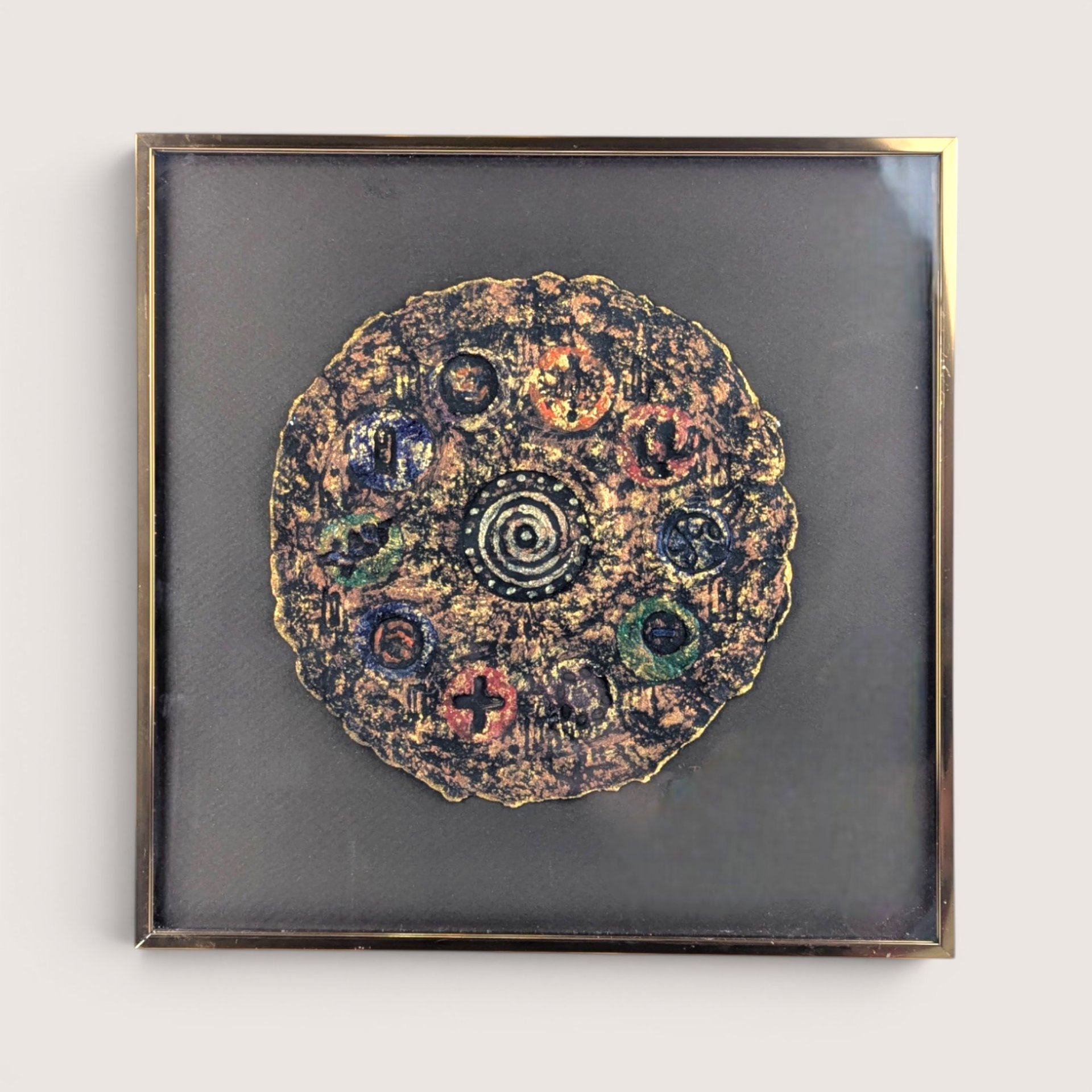 A framed 1997 mixed media painting by Barbara DeVault titled Decadisk featuring a textured circular paper medallion.