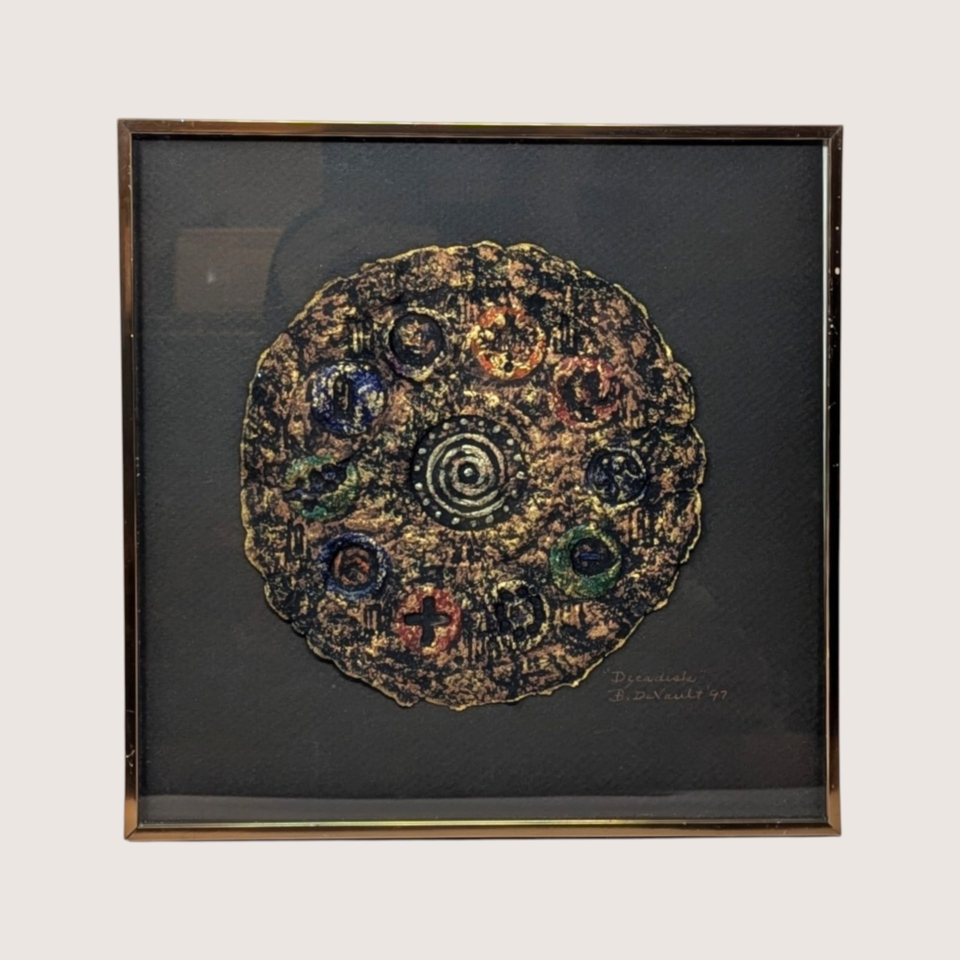 A framed 1997 mixed media painting by Barbara DeVault titled Decadisk featuring a textured circular paper medallion.