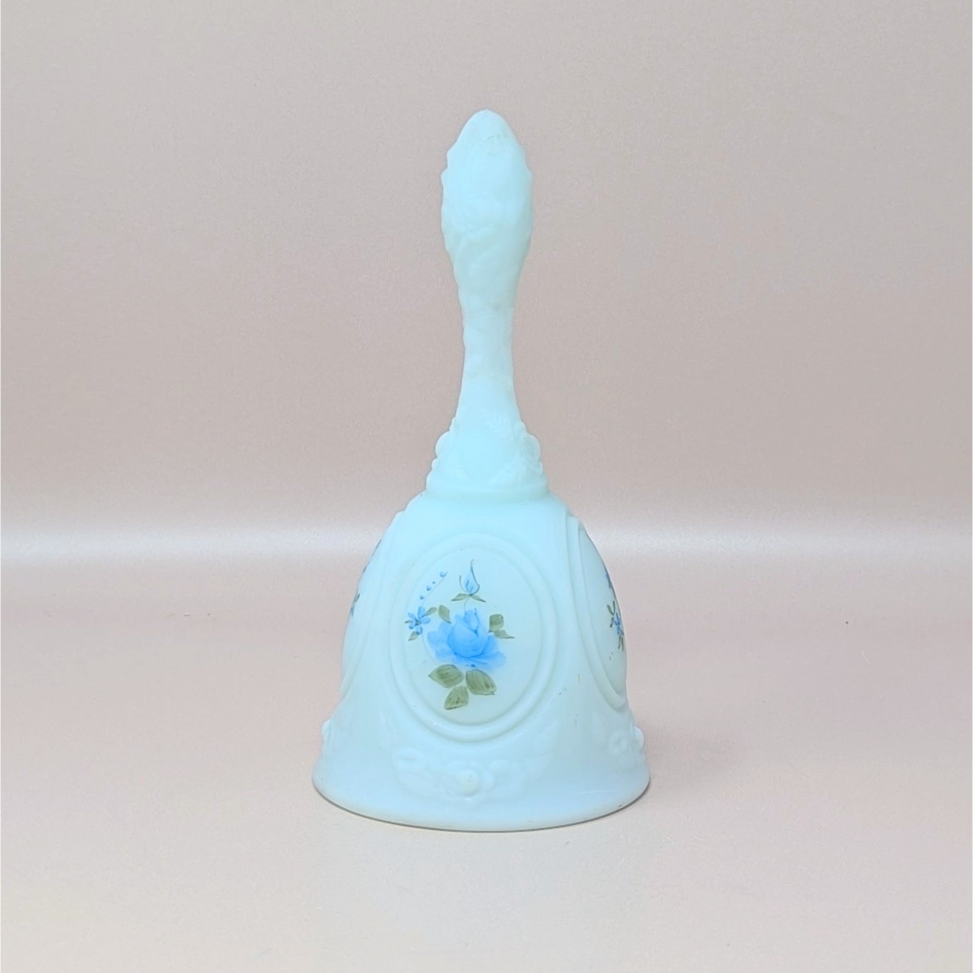 A vintage light blue Fenton milk glass bell featuring a hand-painted blue rose and delicate floral details, signed by artist A.J. Knopp.