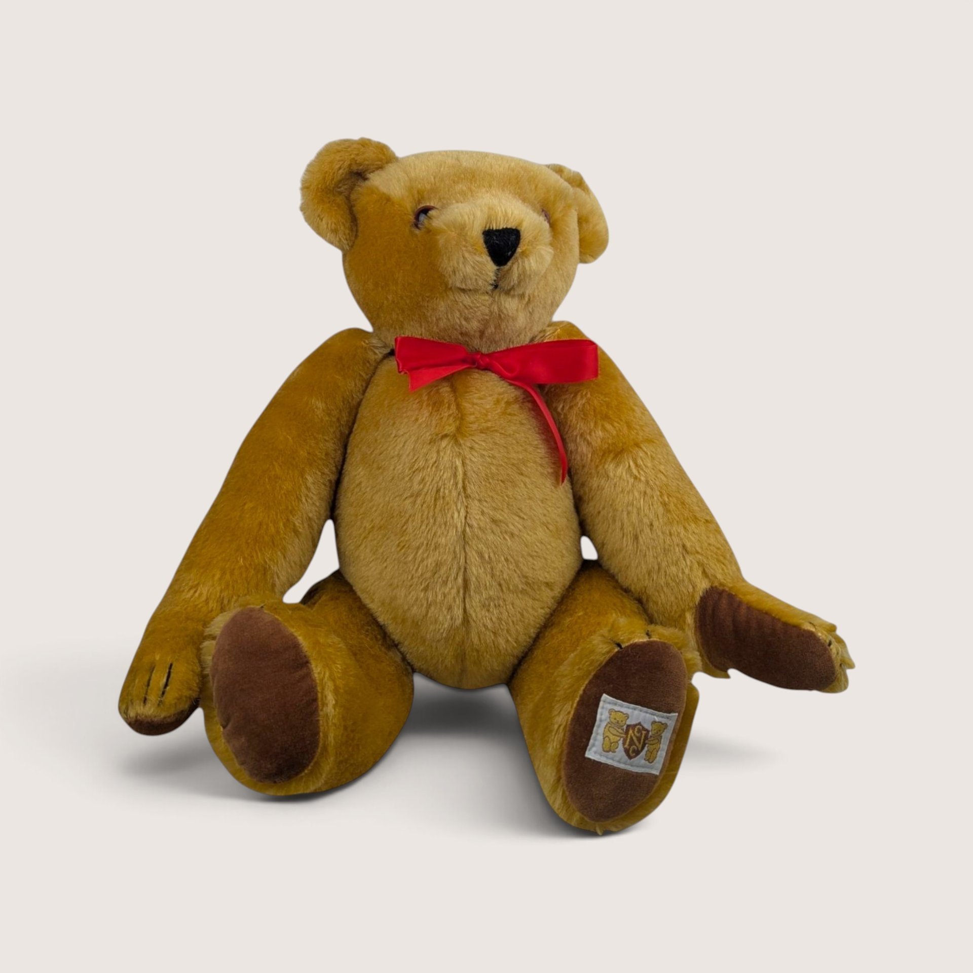 Vintage 1990 House of Nisbet The Way We Were limited edition teddy bear sitting with a red ribbon.