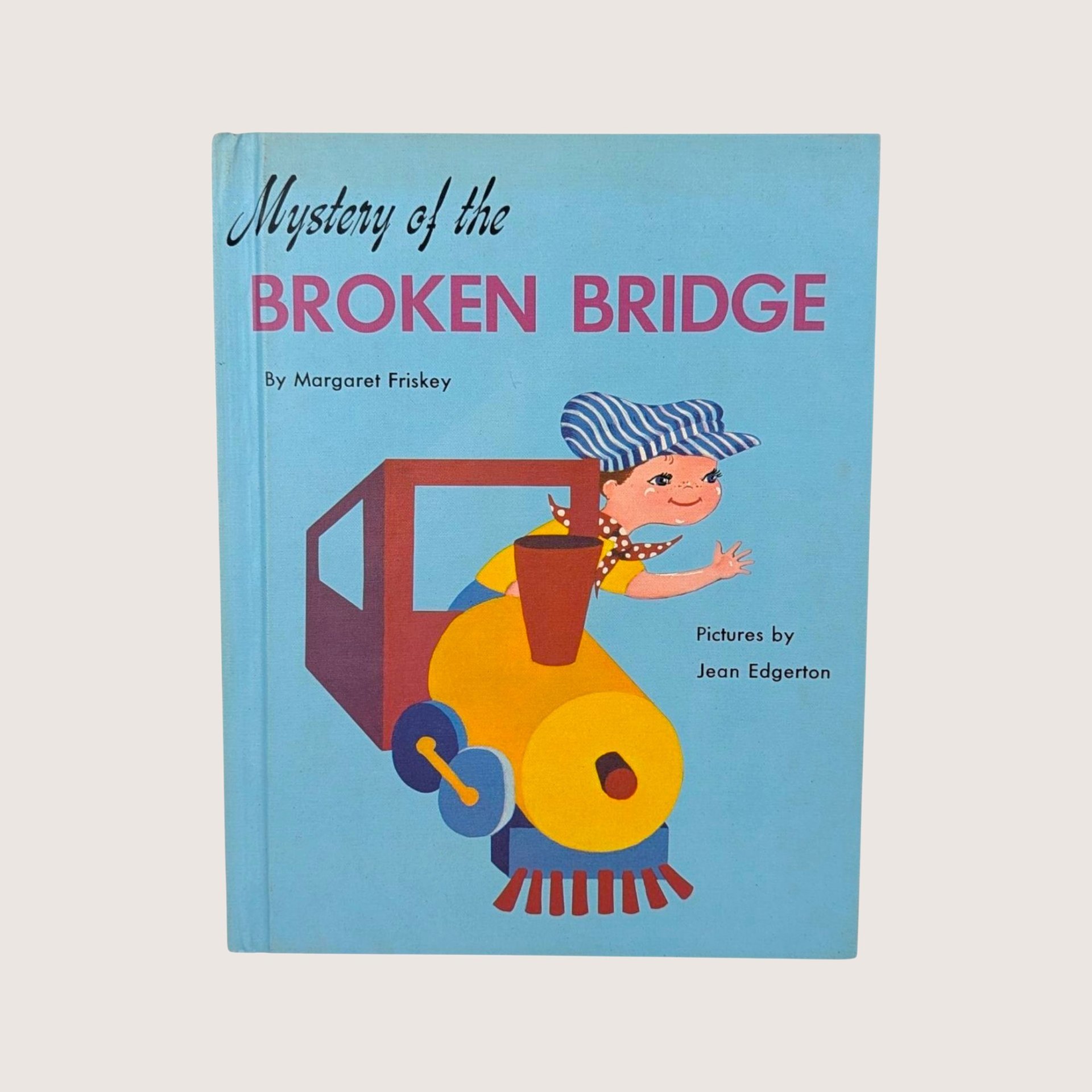 A vintage light blue children's book cover featuring a young boy leaning out of a yellow and red toy train.