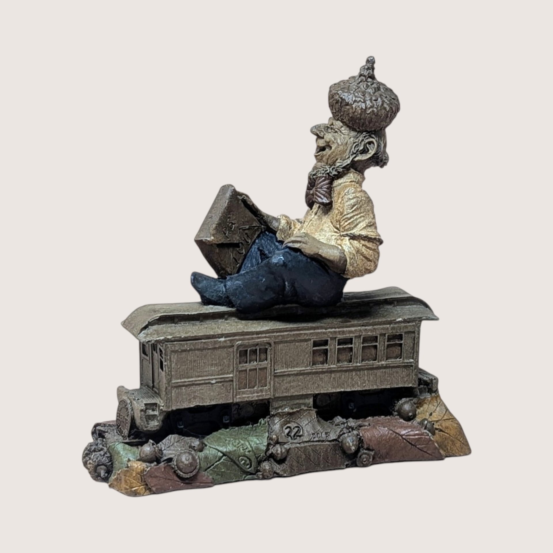 Vintage 1988 Tom Clark gnome named P.S. holding an envelope while sitting on a brown train car base.