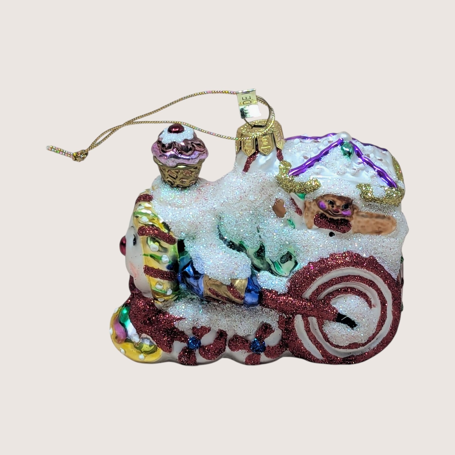 Vintage 2003 Fitz and Floyd blown glass train ornament with glitter snow, peppermint wheels, and cupcake smoke stack.