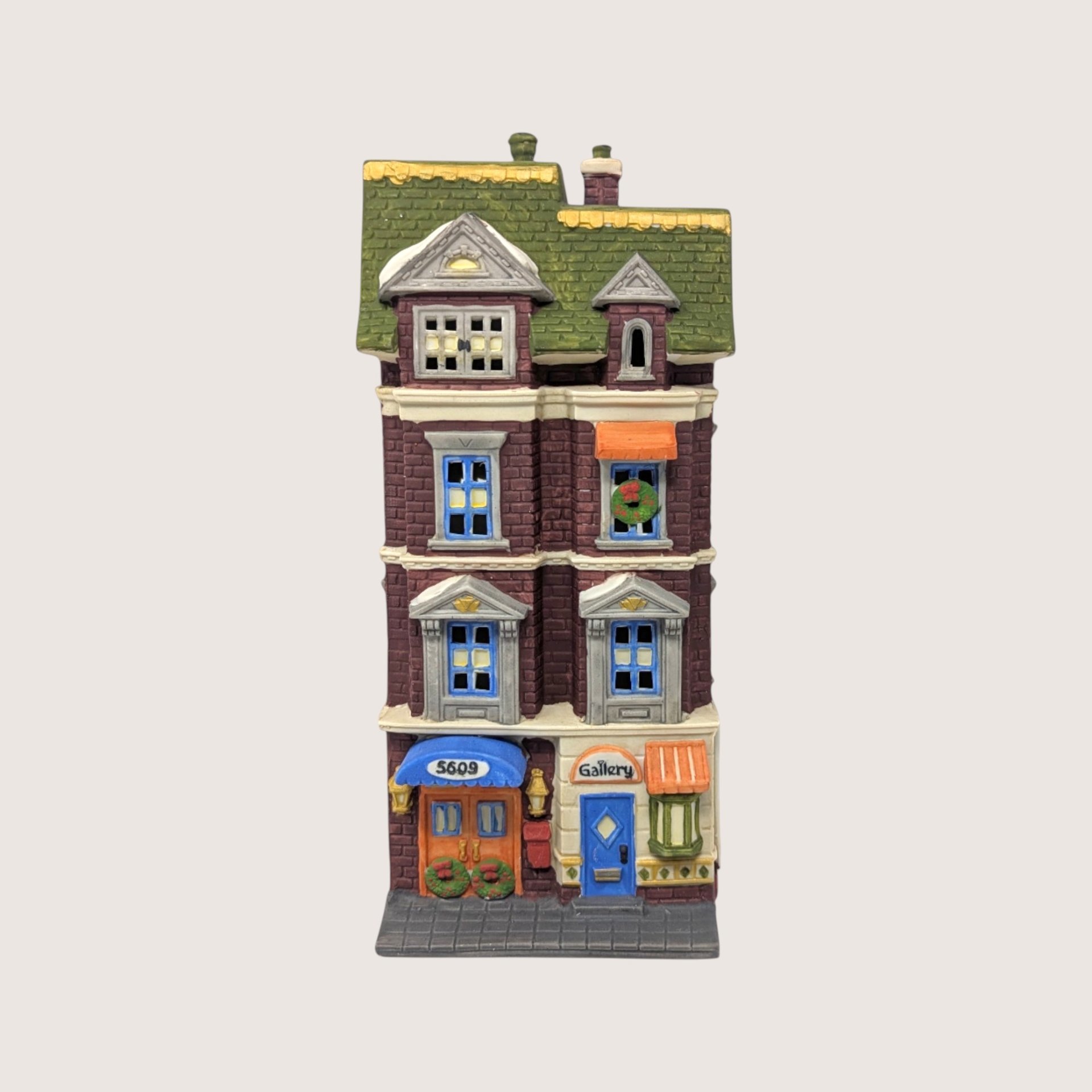 A handpainted porcelain Dept 56 5609 Park Ave Townhouse building on a linen background