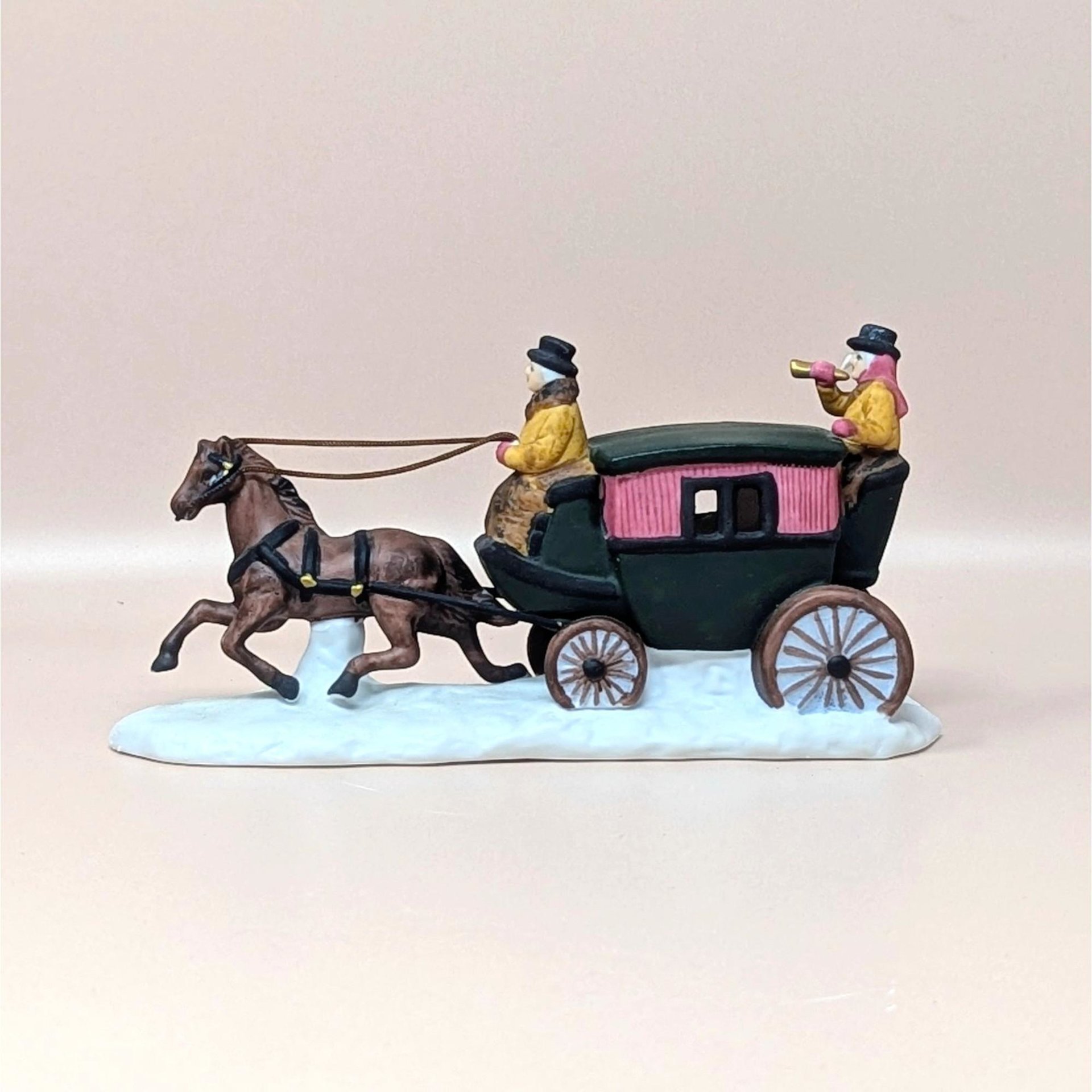 A vintage 1990 Department 56 Heritage Village Dover Coach figurine on a soft pink background. The hand painted porcelain sculpture features a trotting brown horse pulling a green and pink carriage with figures over a snow covered base.