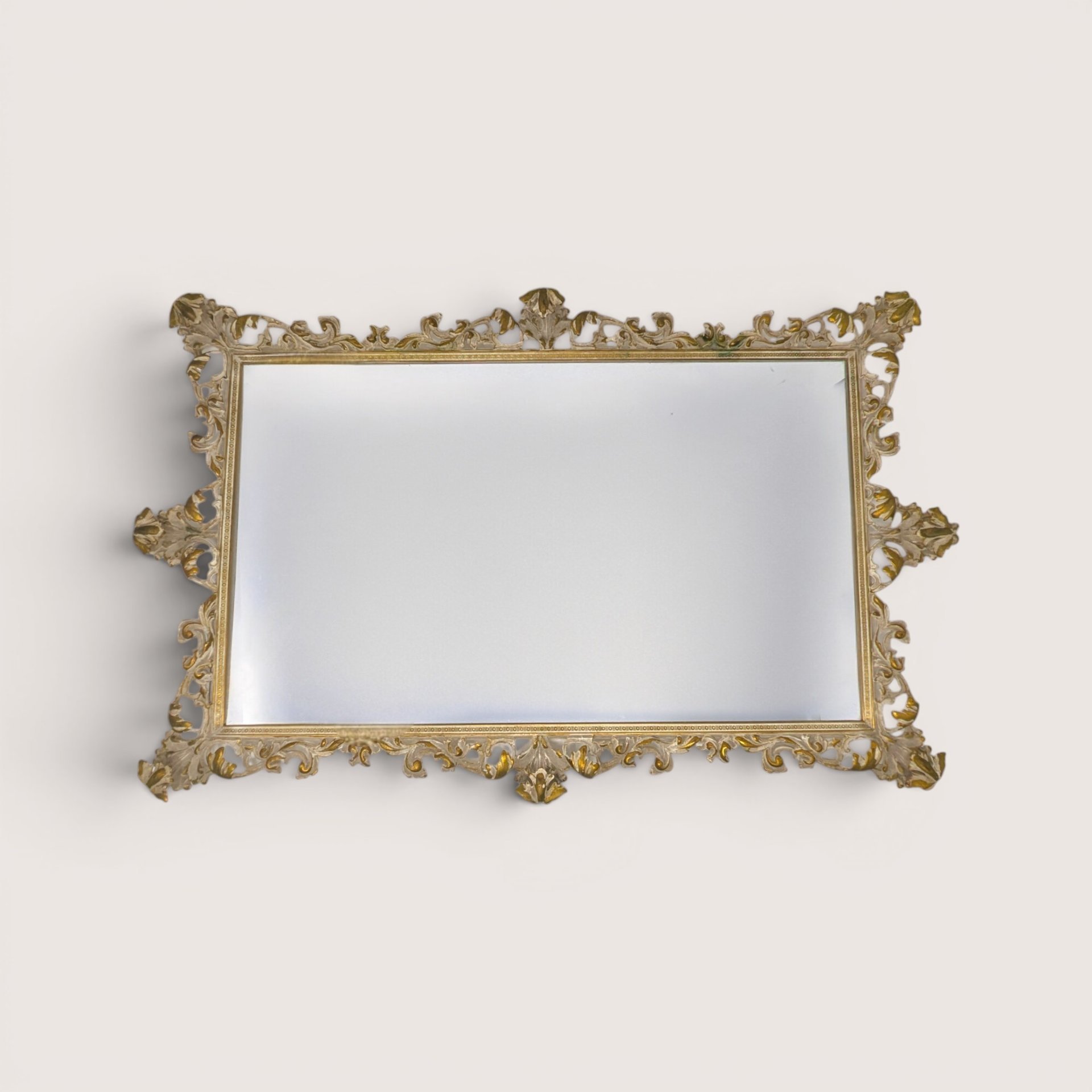 A large antique rectangular vanity tray featuring an ornate gold metal filigree border frame and a mirrored glass surface.