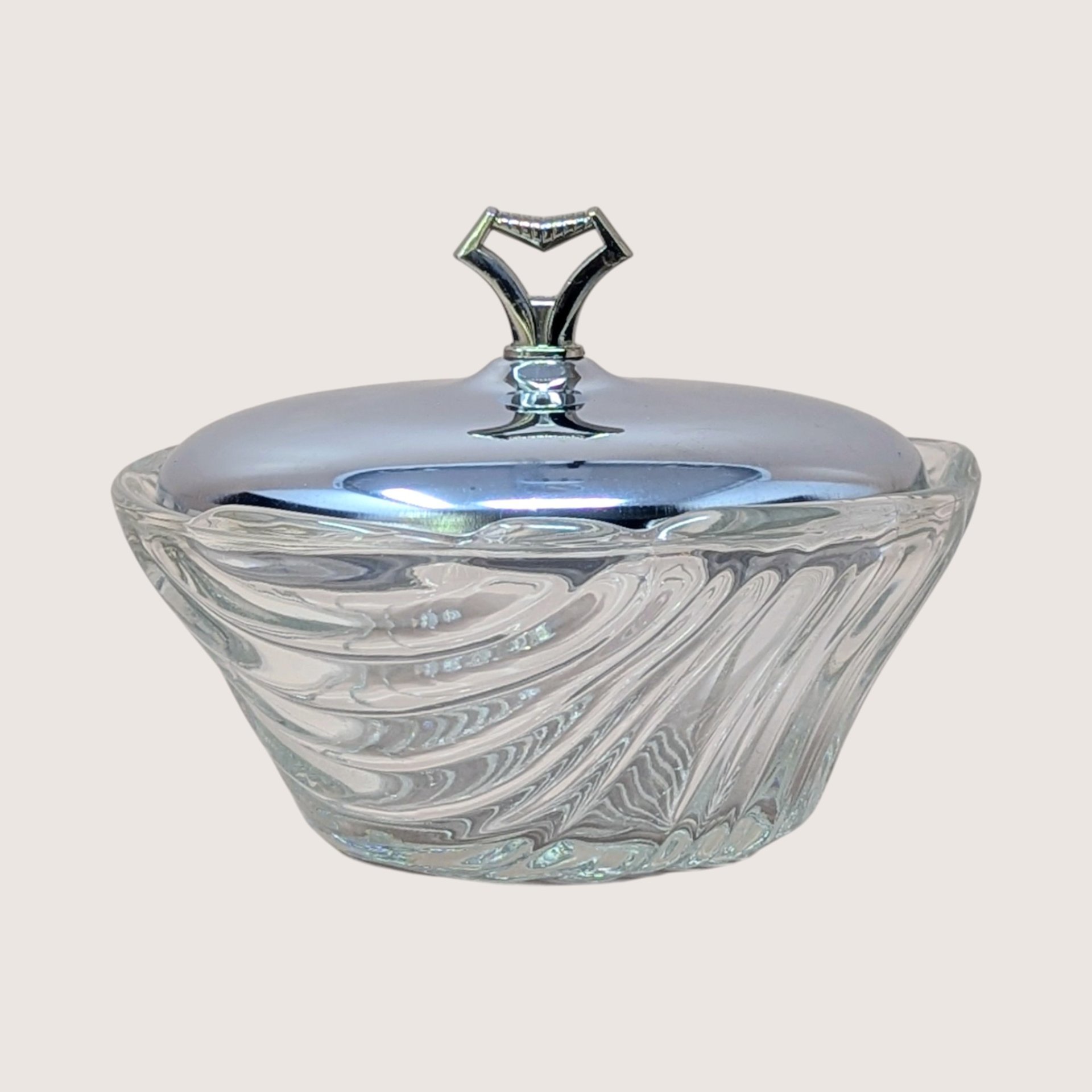 Vintage Kromex clear swirled glass candy dish with a shiny silver chrome dome lid and geometric handle.