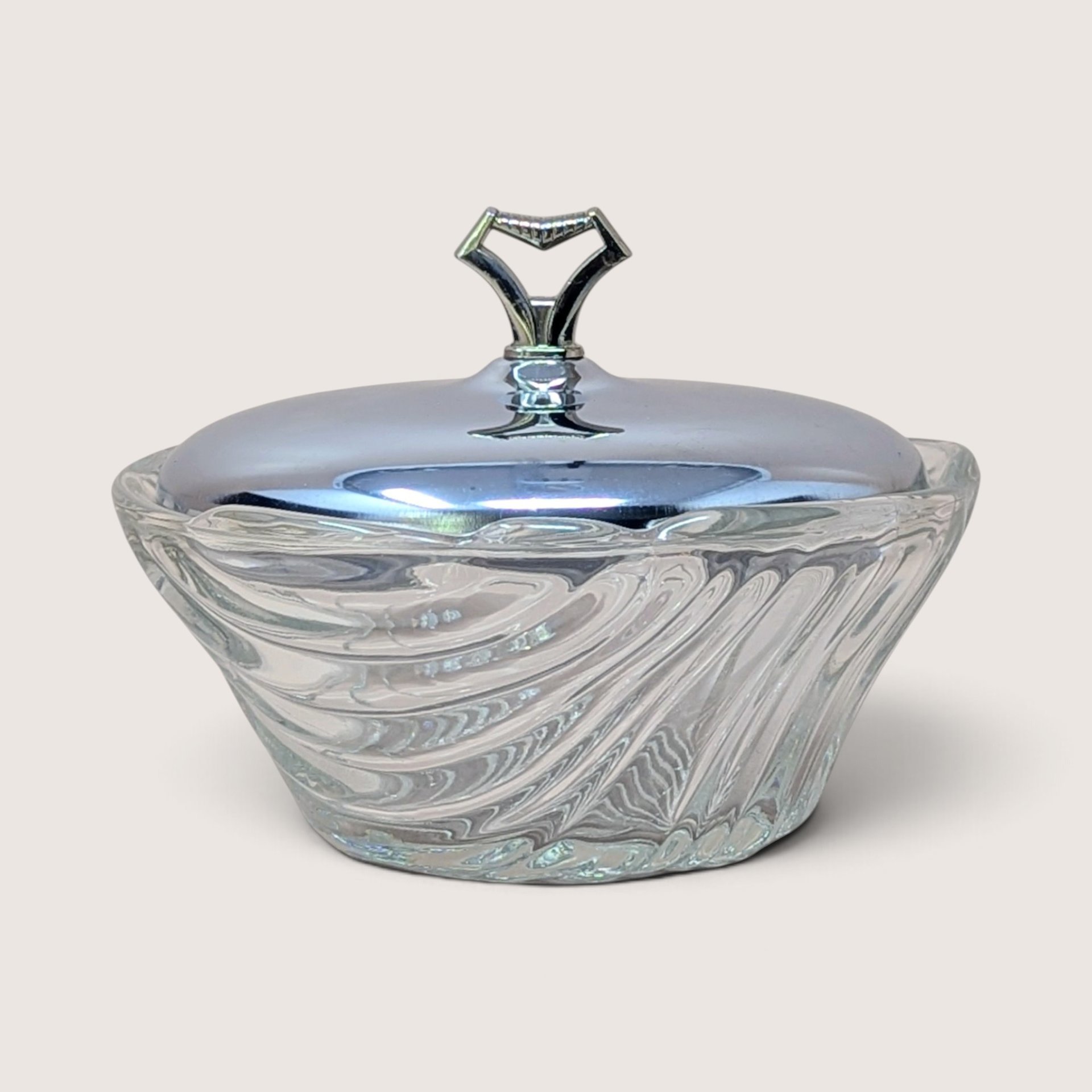 Vintage clear swirl glass vanity dish with a fitted silver chrome lid topped with a geometric handle.
