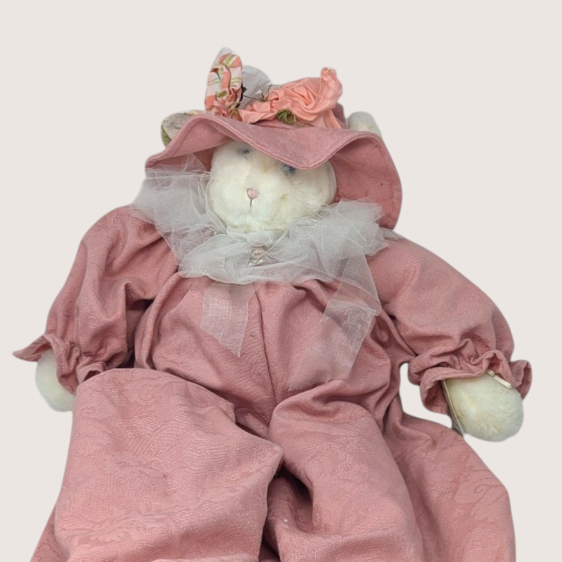Vintage large artisan fabric cat plush doll named Jolie in a pink bonnet and romper outfit.