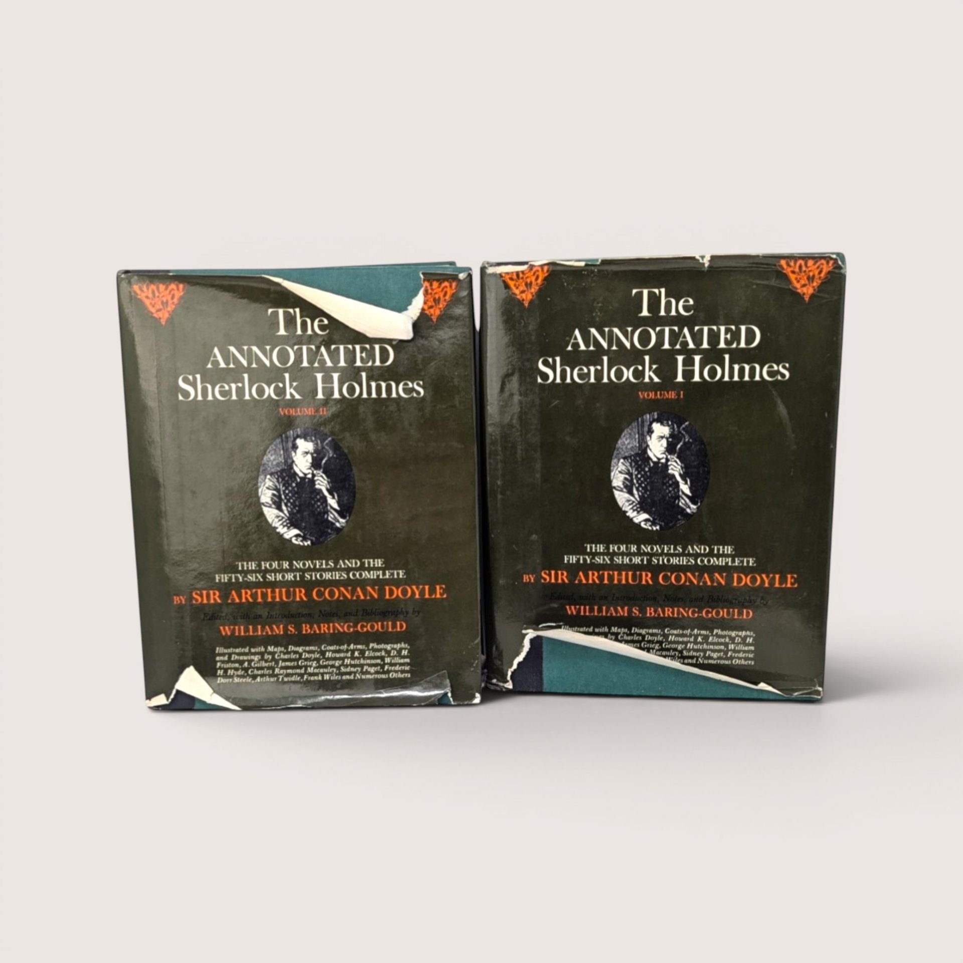 A vintage two-volume hardcover set of The Annotated Sherlock Holmes with torn dark green dust jackets