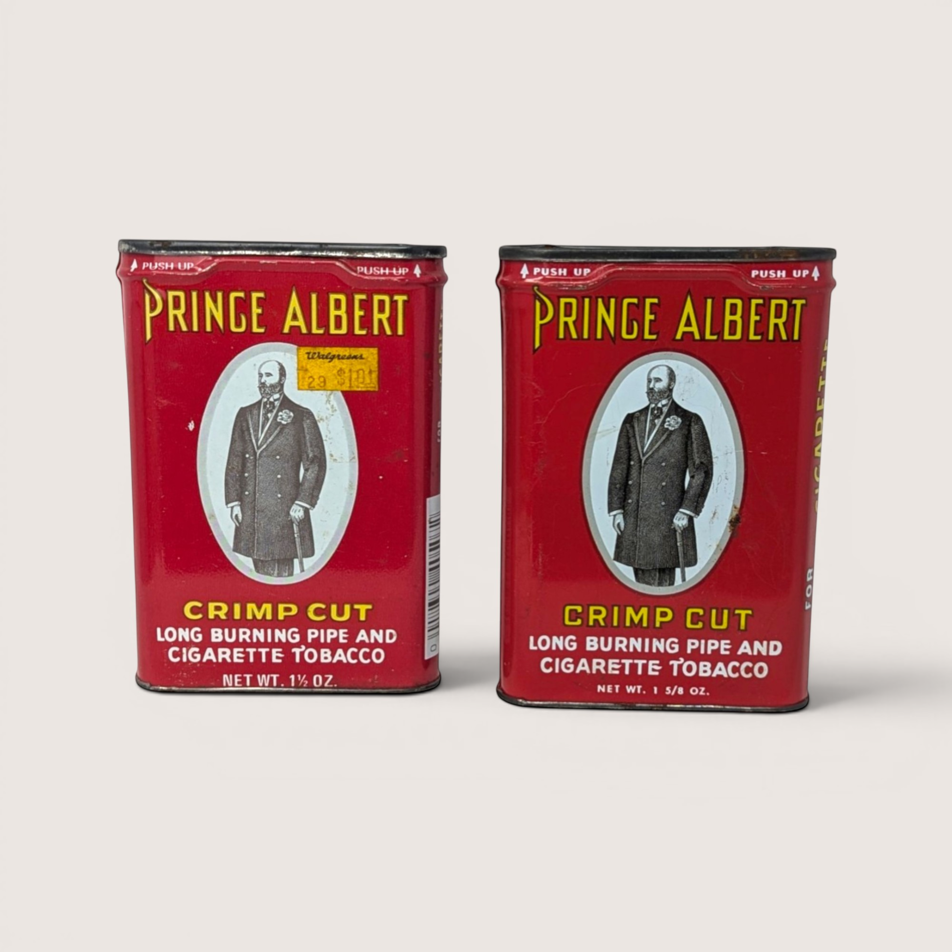 Pair of vintage empty red Prince Albert pocket tobacco tins with a portrait of Prince Albert on the front.