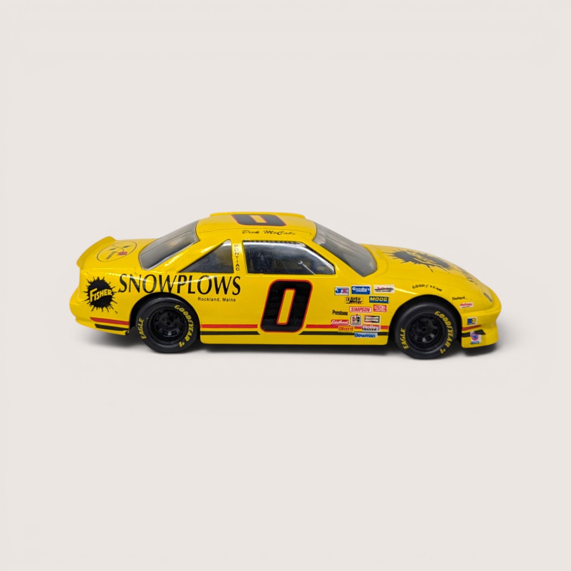 A yellow 1 to 24 scale die cast stock car model with Fisher Snowplows branding and the number zero on the side.